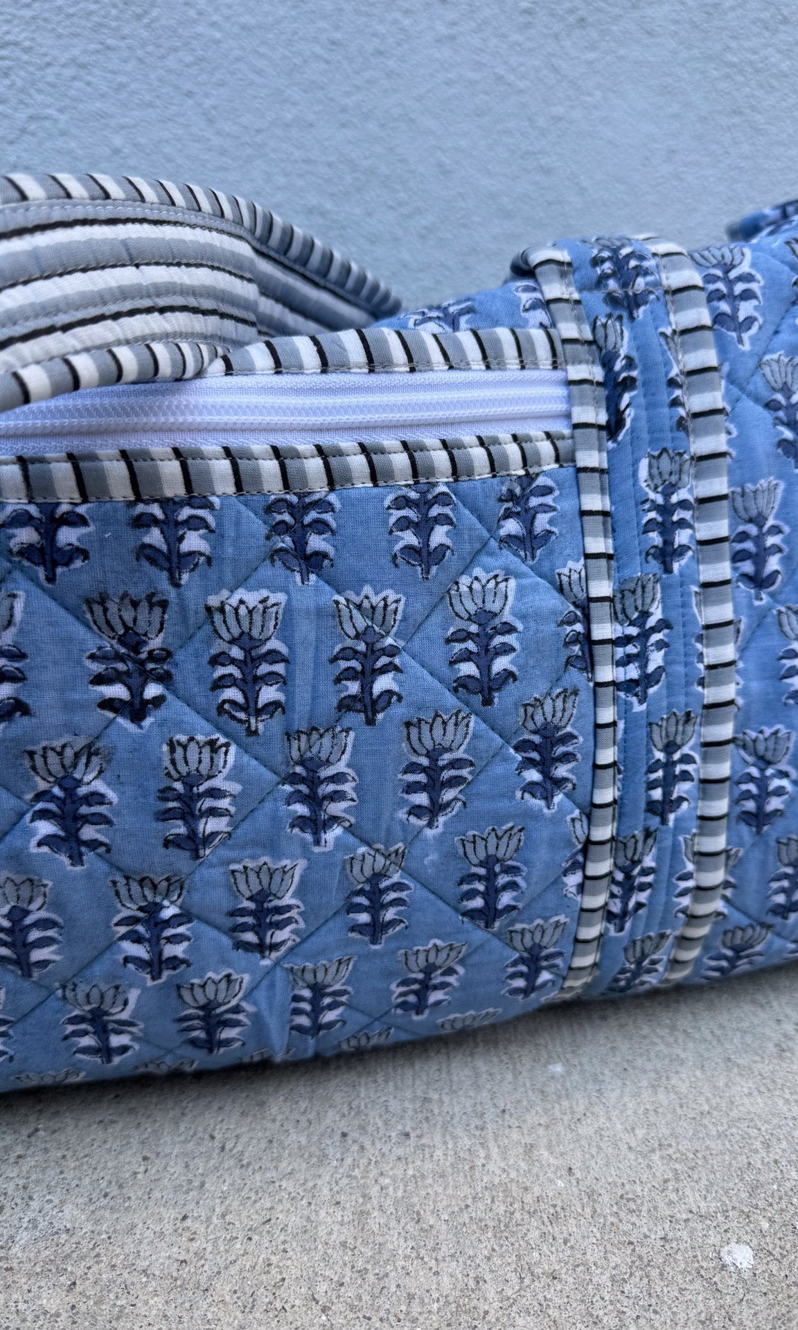 blue quilted block print duffle bag