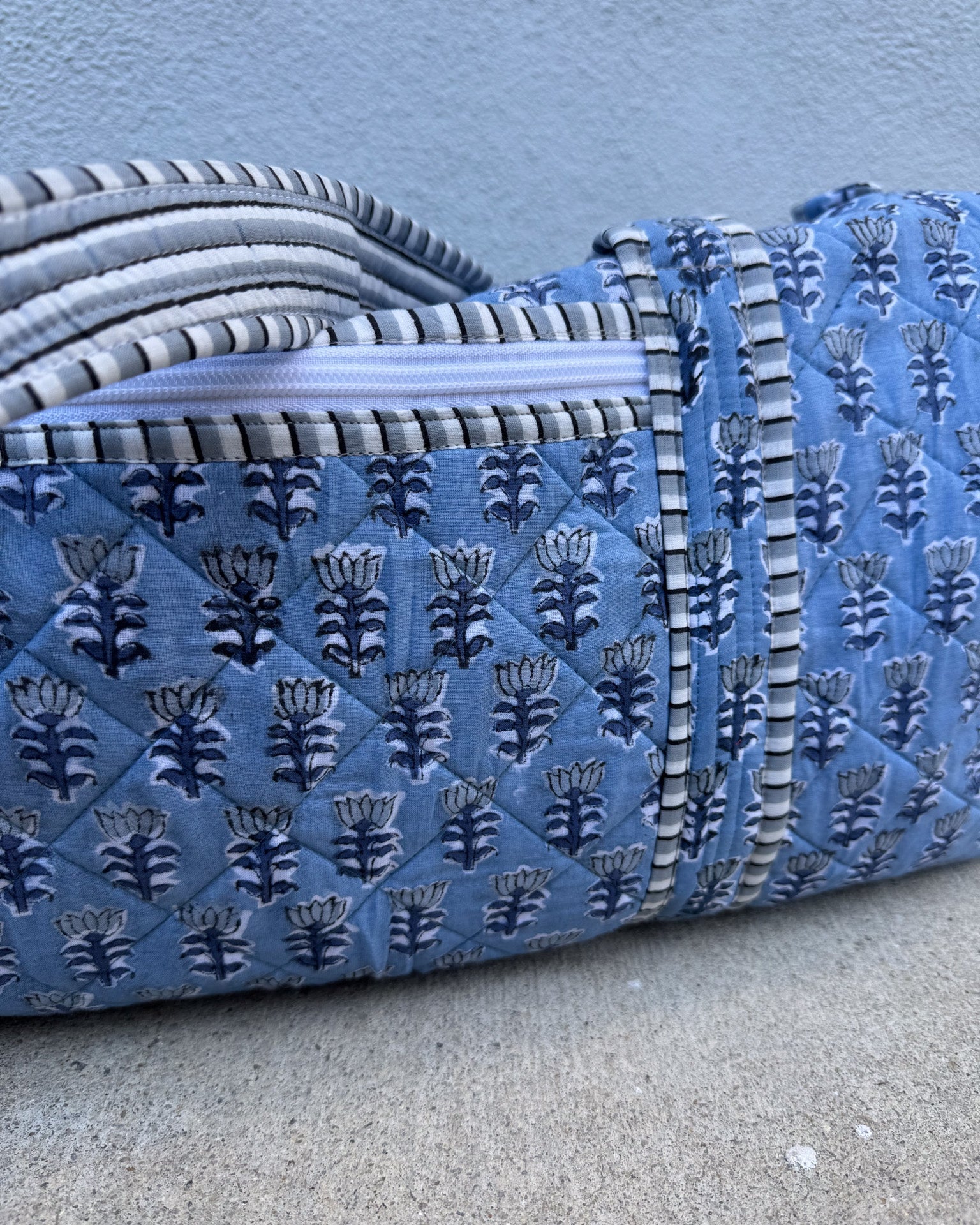 blue quilted block print duffle bag