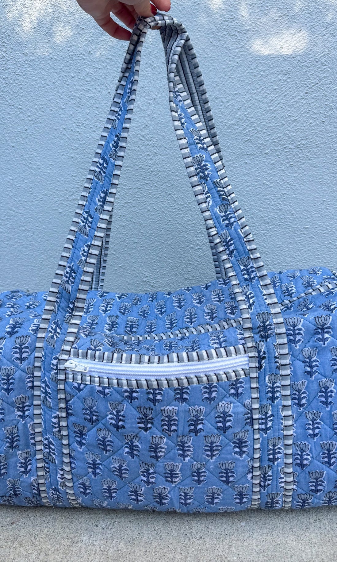 blue quilted block print duffle bag