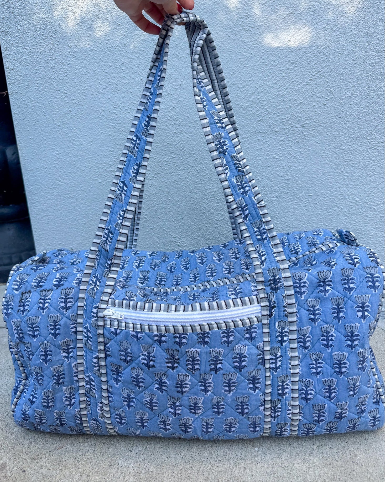 blue quilted block print duffle bag