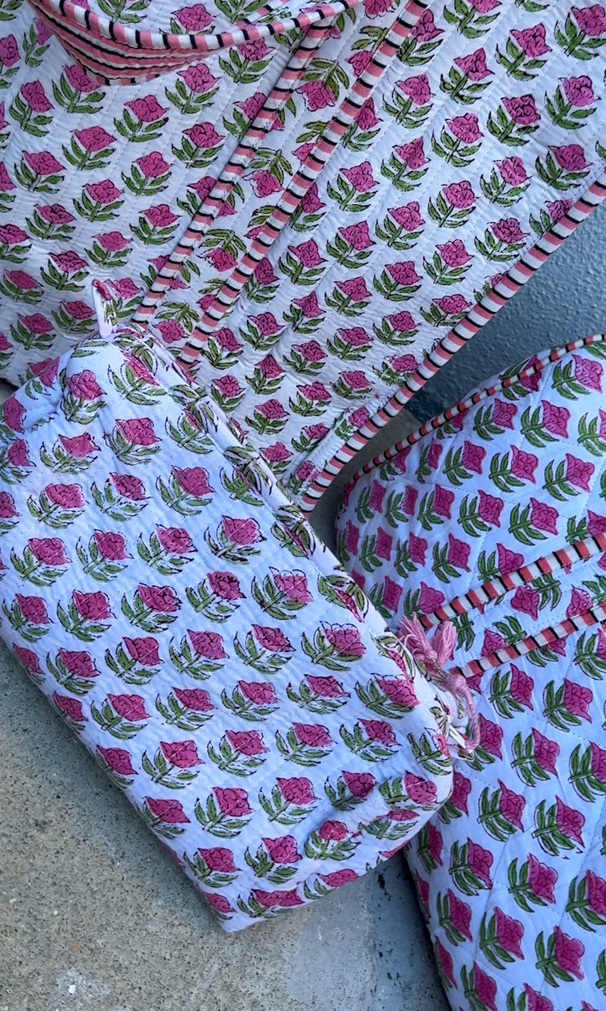 Set of fabric pieces with pink floral pattern on a gray surface
