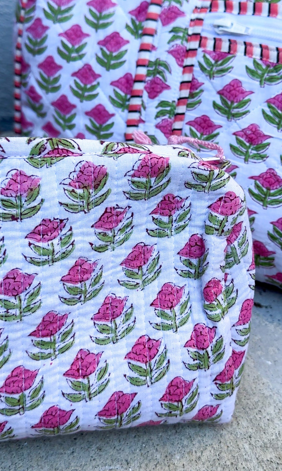 Fabric bags with floral pattern on a concrete surface