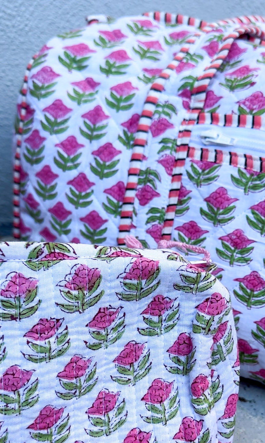 Fabric bags with floral pattern on a concrete surface