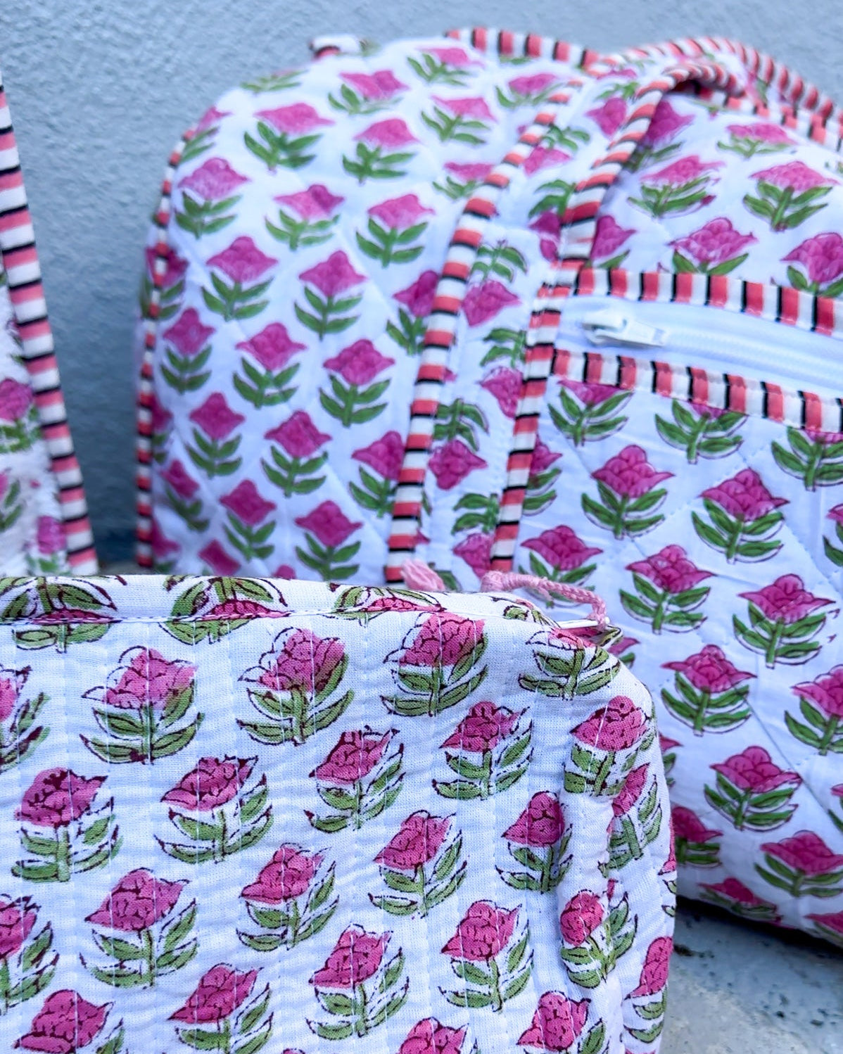Fabric bags with floral pattern on a concrete surface