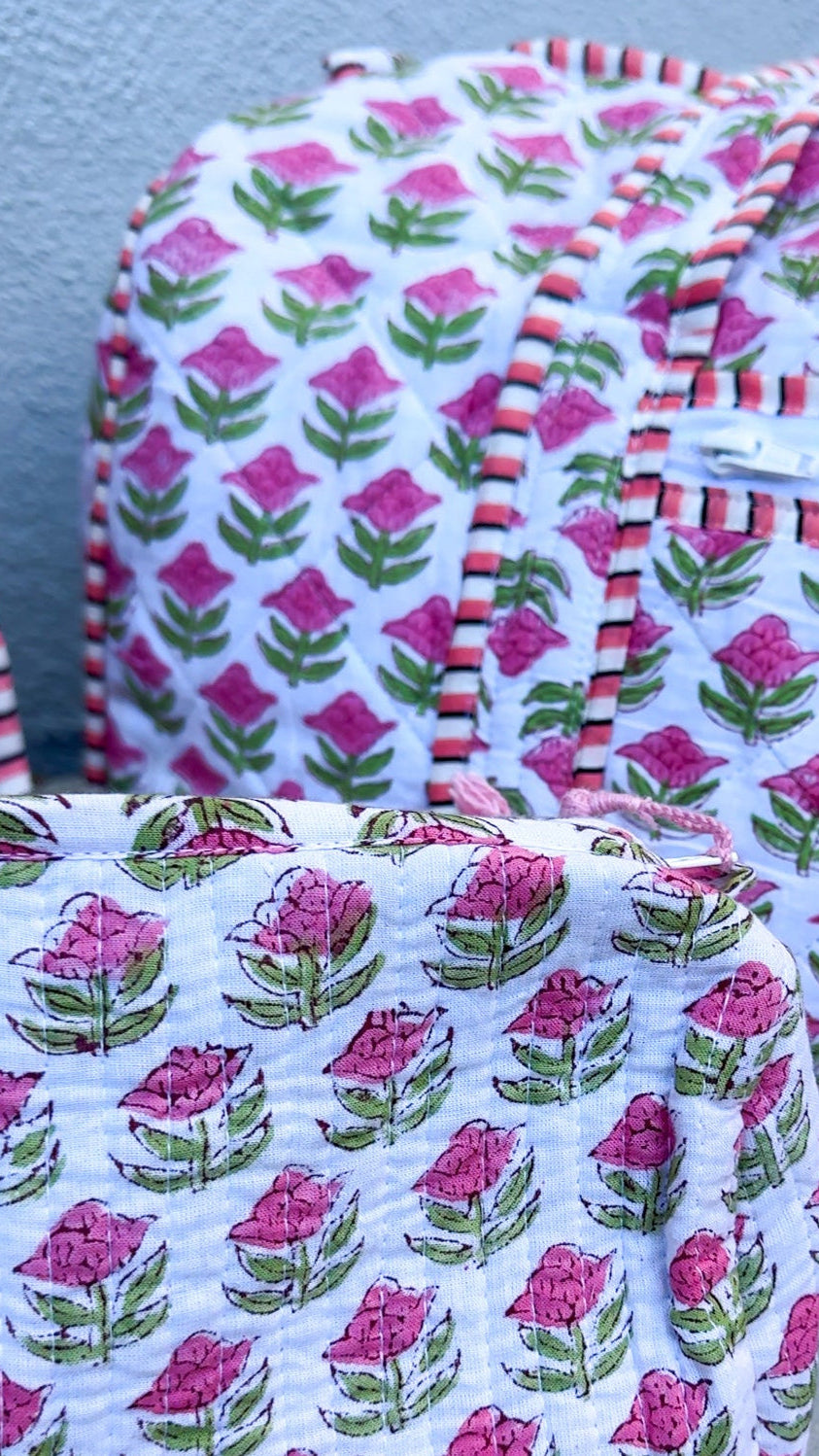 Fabric bags with floral pattern on a concrete surface