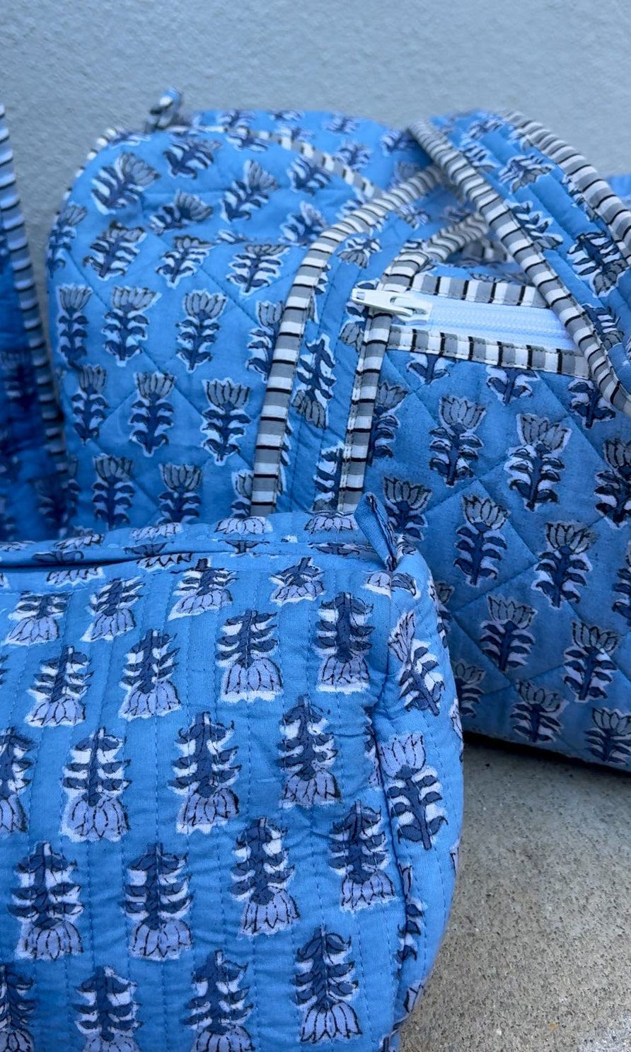 blue quilted block print duffle bag