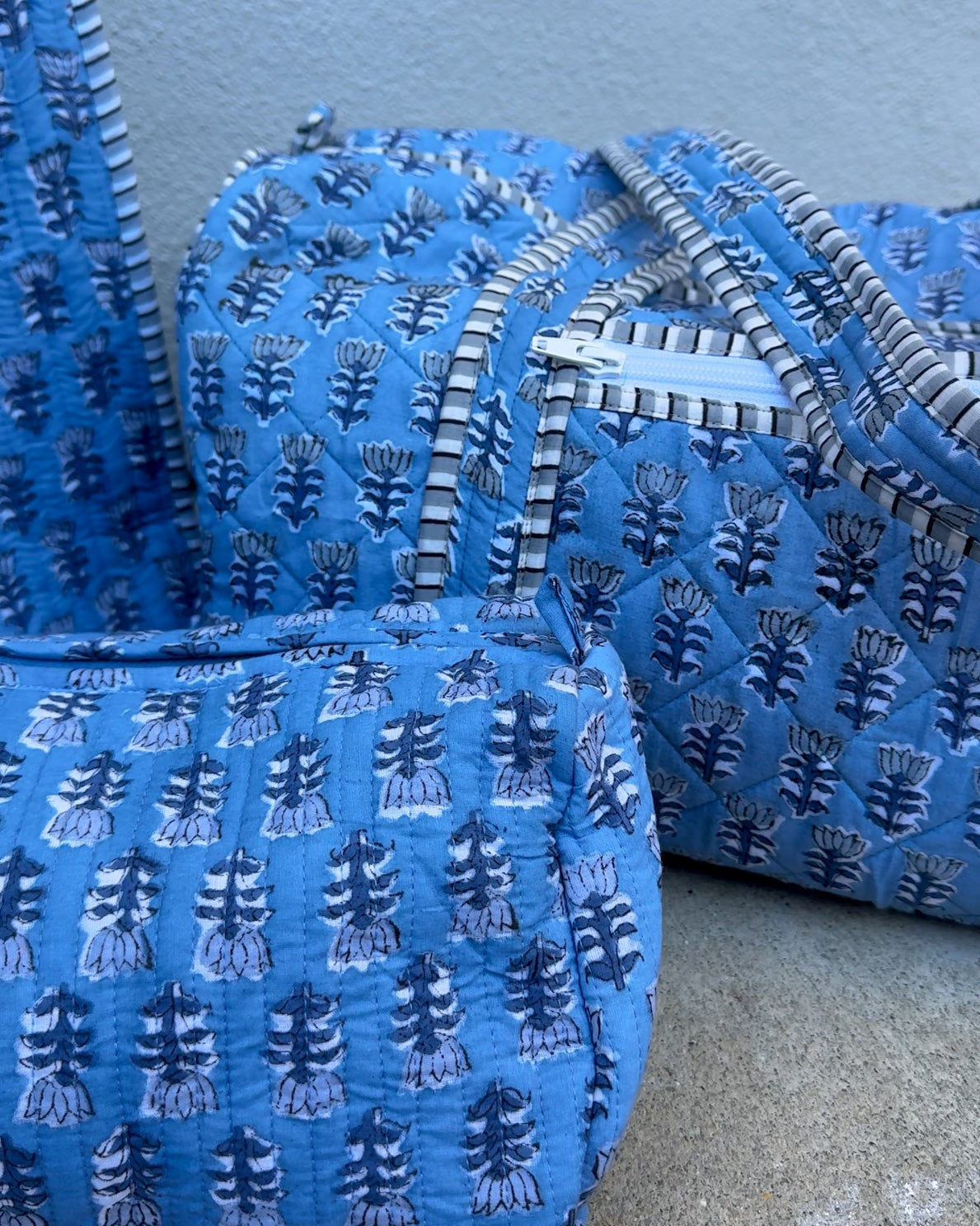 blue quilted block print duffle bag