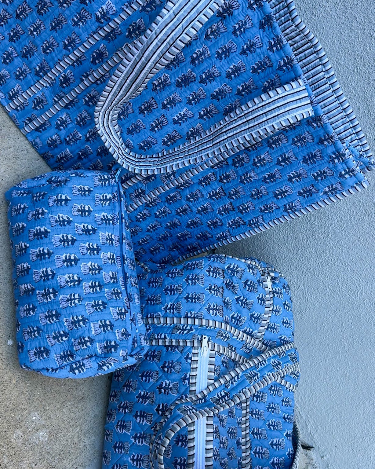 blue quilted block print duffle bag