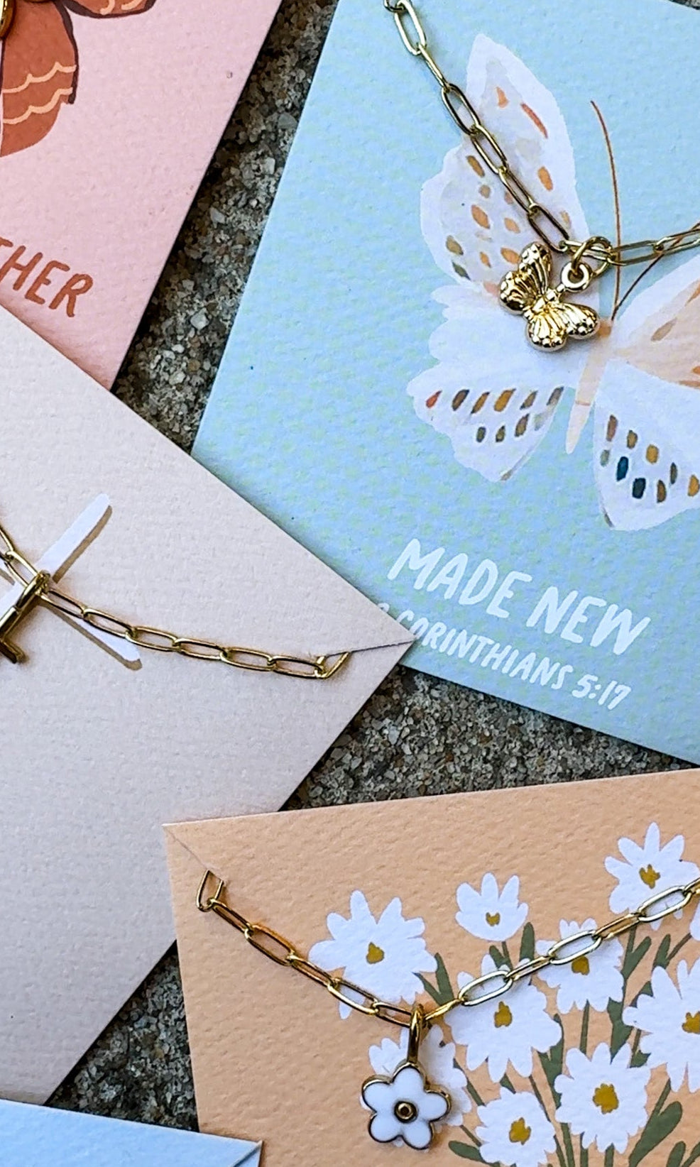 Set of cards with butterfly and floral designs on a textured surface