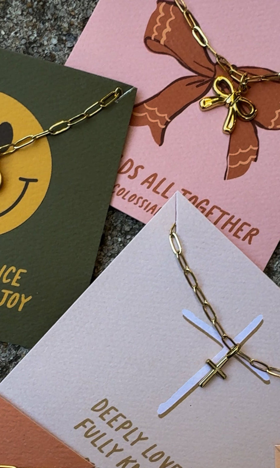 bow necklace, cross necklace, smiley face necklace