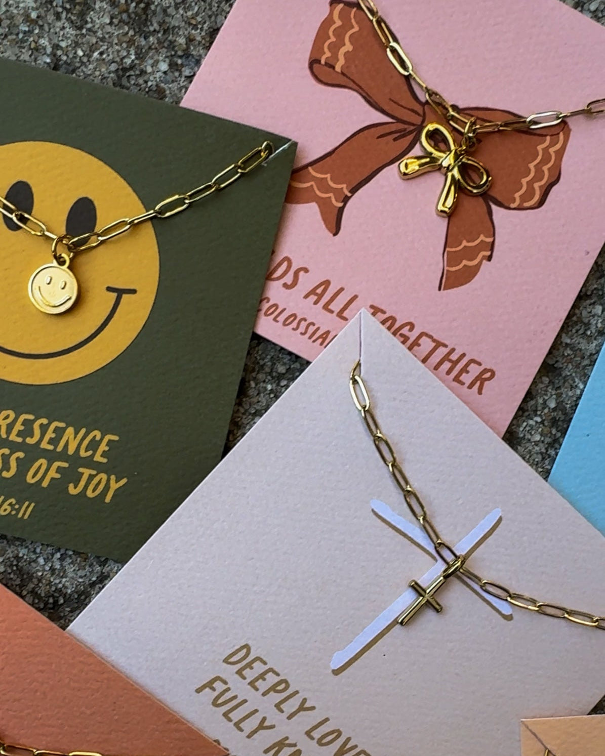 bow necklace, cross necklace, smiley face necklace