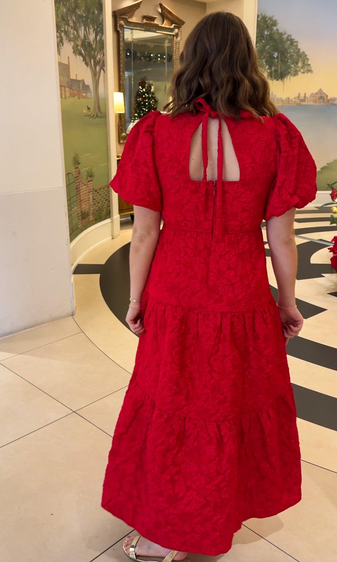 red jacquard maxi dress with puff sleeves and tiered skirt bottom and open back tie bow v neck holiday christmas dress