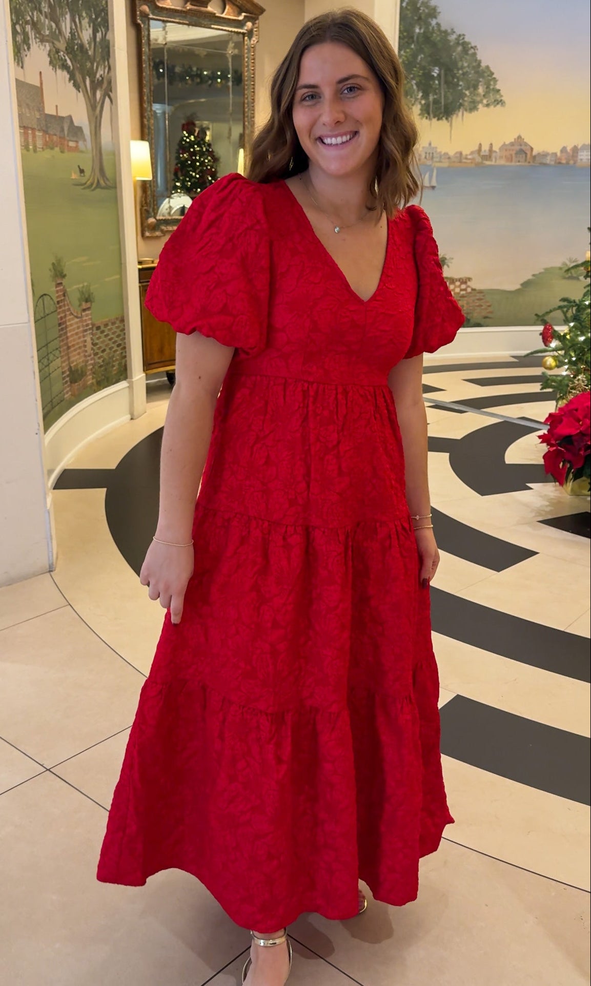 red jacquard maxi dress with puff sleeves and tiered skirt bottom and open back tie bow v neck holiday christmas dress