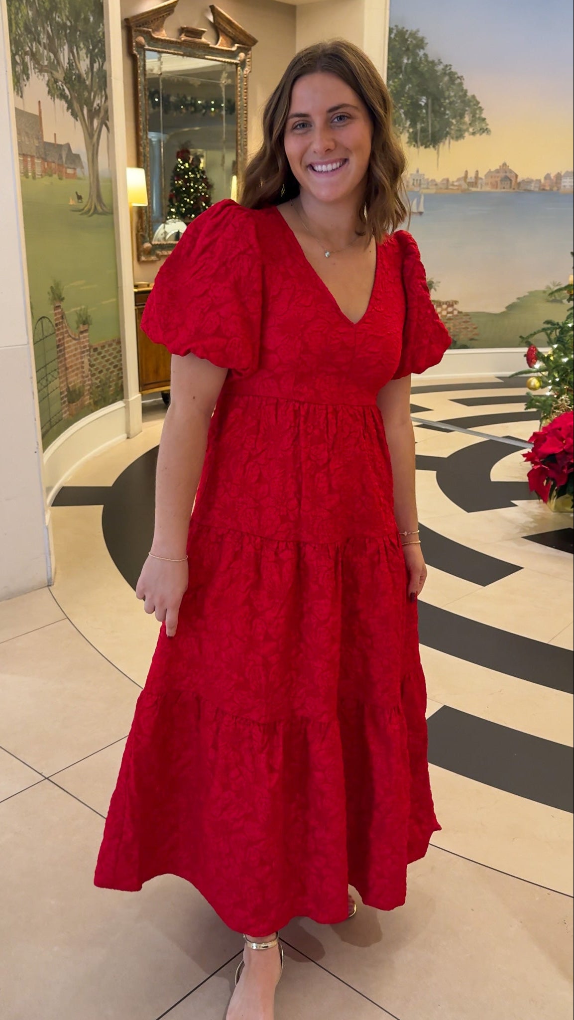 red jacquard maxi dress with puff sleeves and tiered skirt bottom and open back tie bow v neck holiday christmas dress