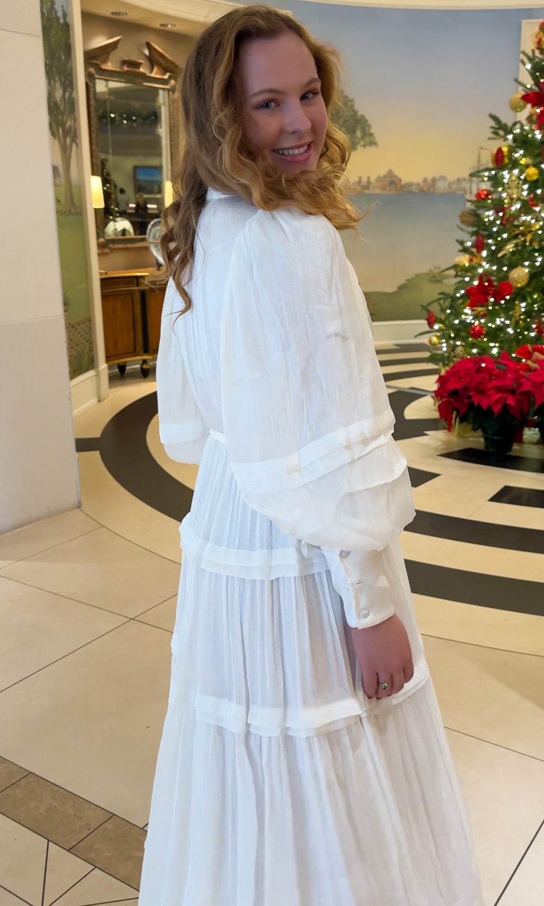 Shimmer crinkled long sleeve tiered midi dress with V-neckline, stand collar, waist tie belt, and flowing skirt.