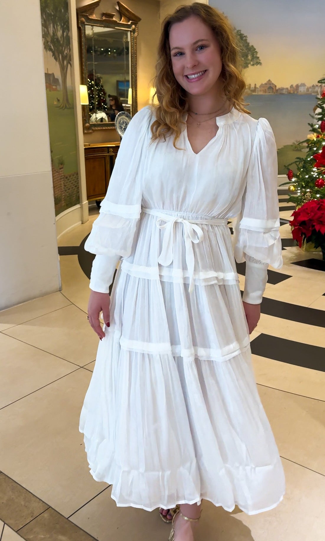 Shimmer crinkled long sleeve tiered midi dress with V-neckline, stand collar, waist tie belt, and flowing skirt.