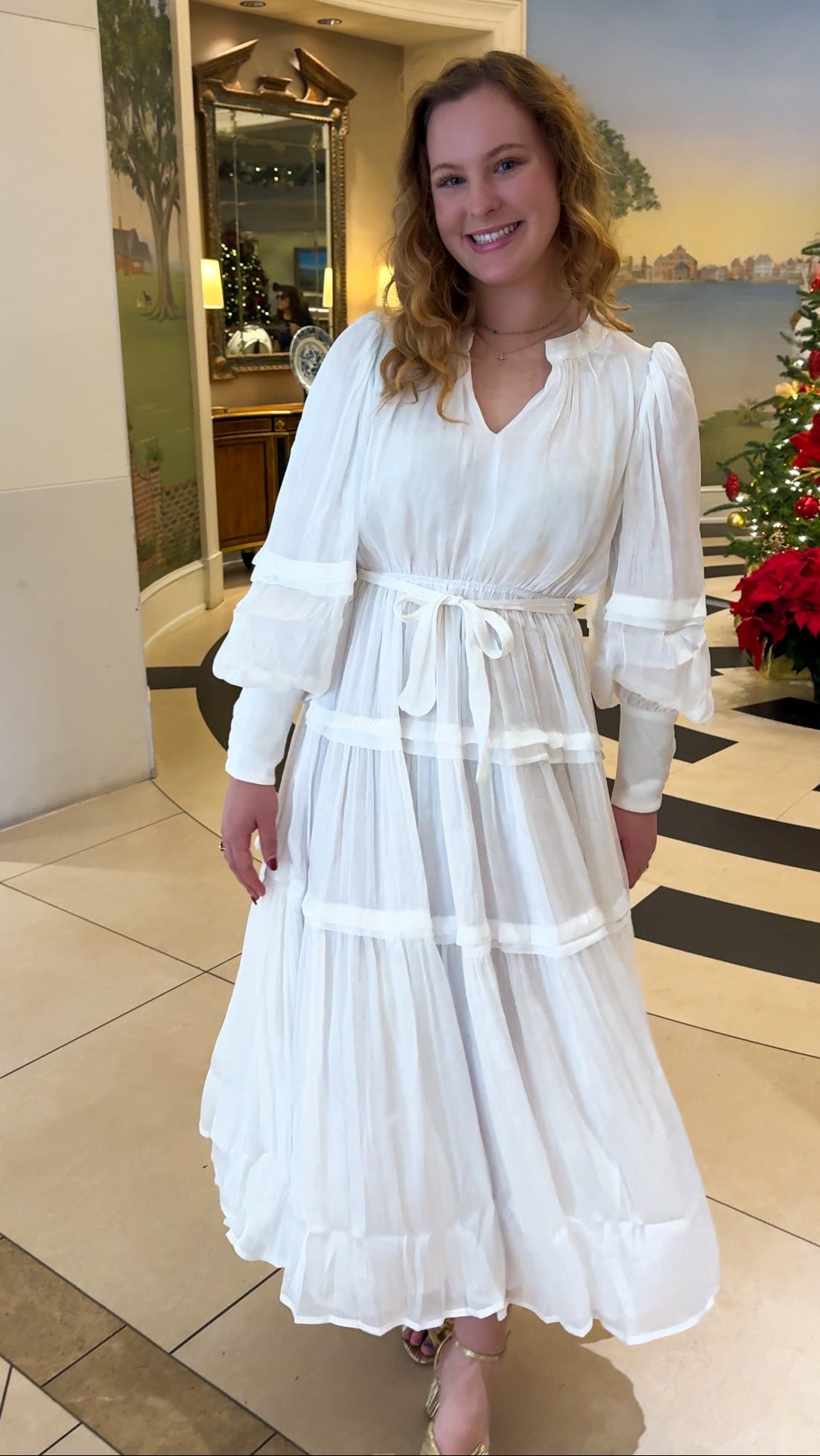 Shimmer crinkled long sleeve tiered midi dress with V-neckline, stand collar, waist tie belt, and flowing skirt.