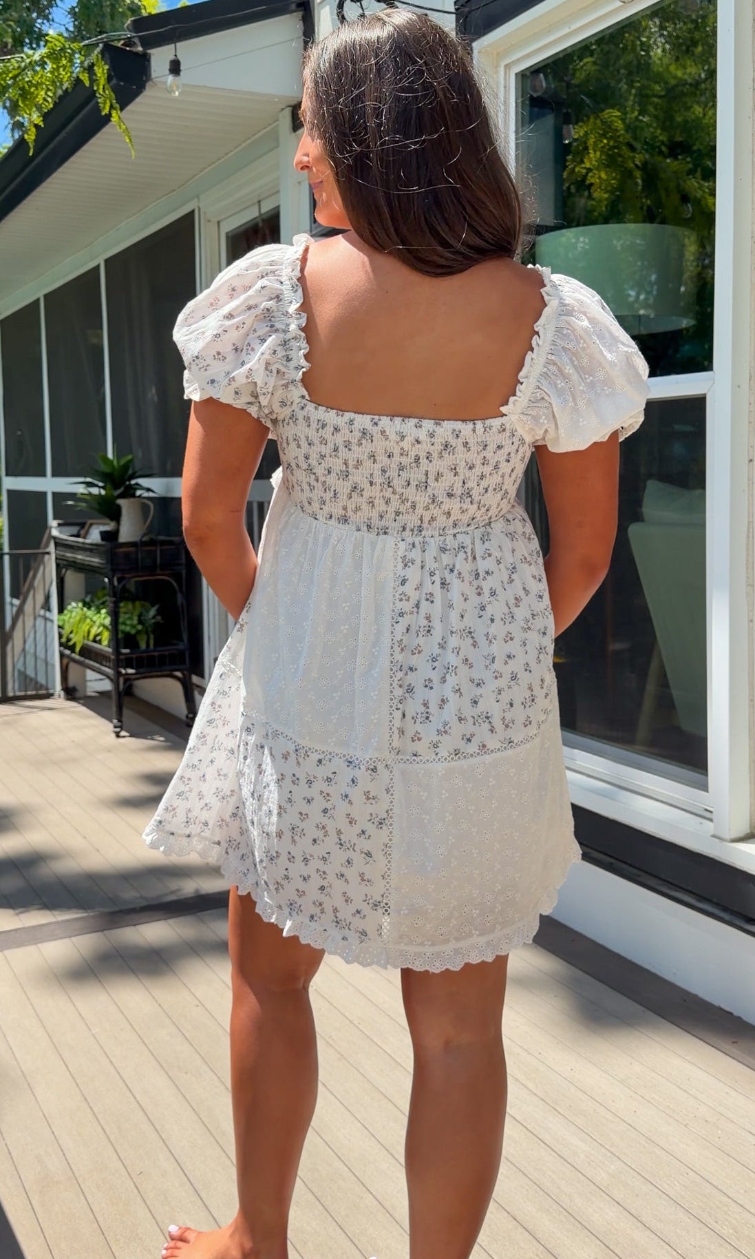 cream floral mini dress with eyelet lace, puff sleeves, scalloped neckline, and front tie detail