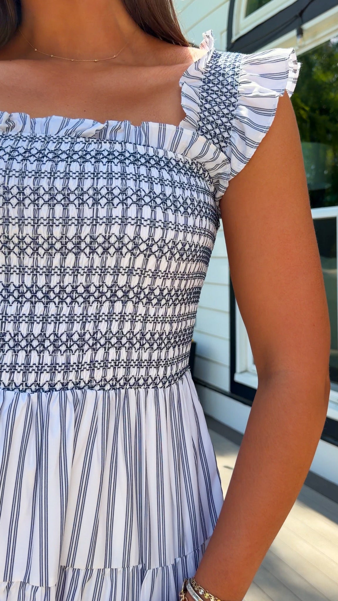 white and navy striped midi dress with smocked bodice, ruffle straps, and tiered skirt