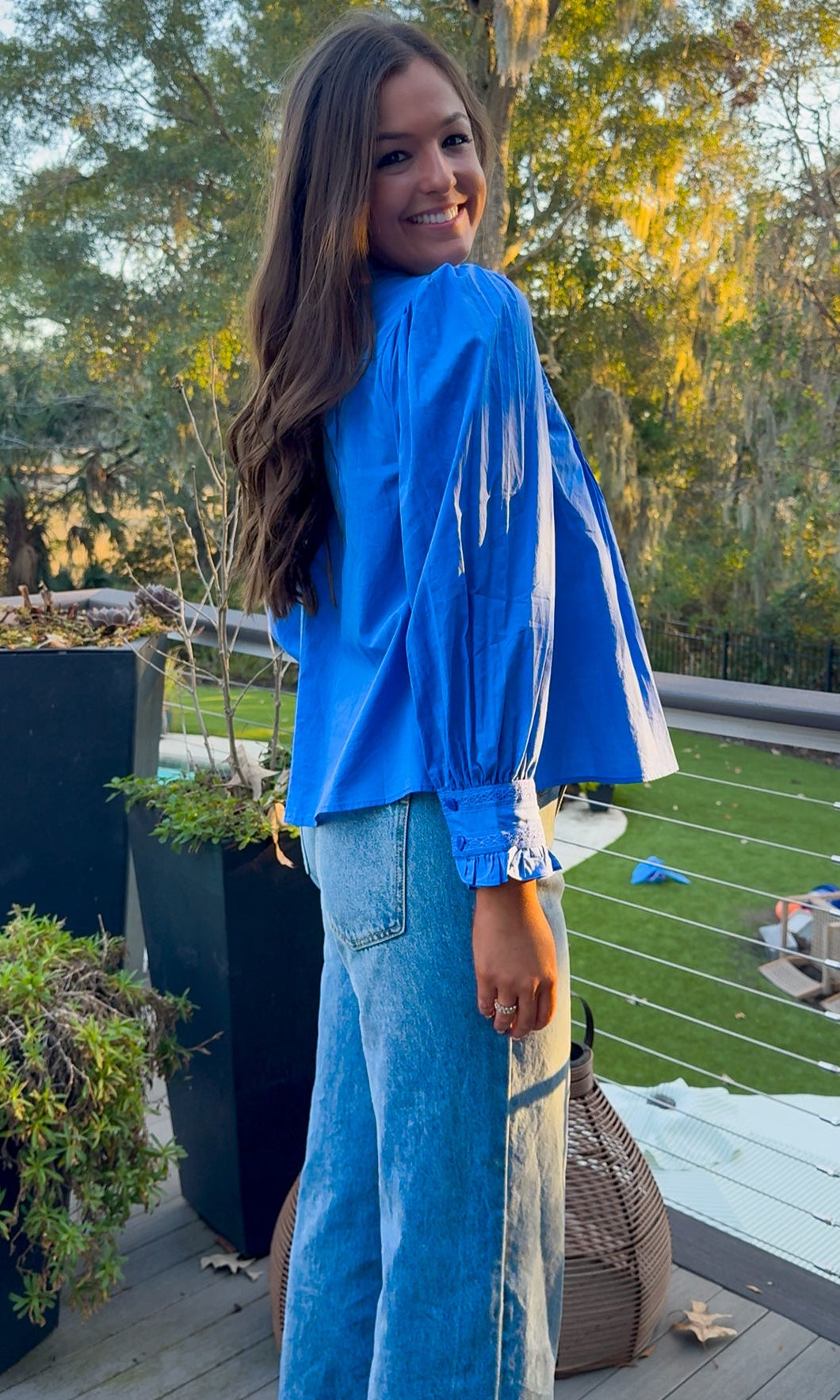 Azure blue embroidered blouse with puff sleeves and relaxed fit.