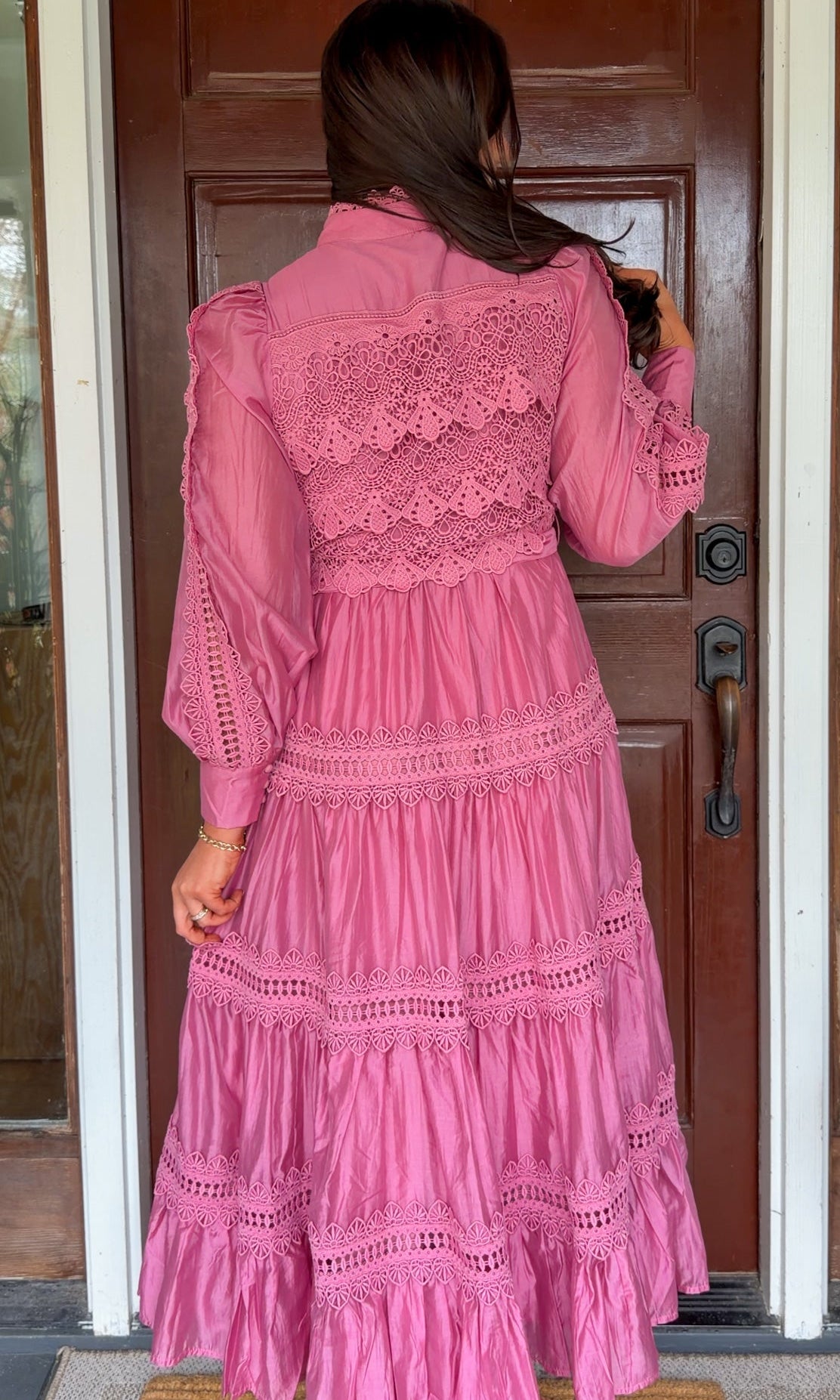 a satin midi dress with crochet lace panels, button-down front, long sleeves, and a self-tie waist in a soft plum color. pink mauve high neck