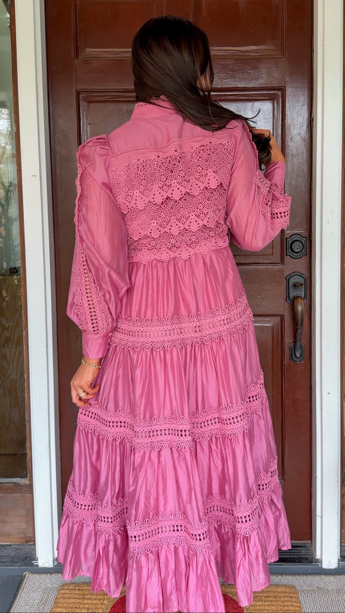 a satin midi dress with crochet lace panels, button-down front, long sleeves, and a self-tie waist in a soft plum color. pink mauve high neck