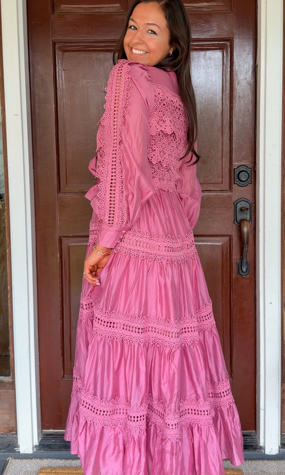 a satin midi dress with crochet lace panels, button-down front, long sleeves, and a self-tie waist in a soft plum color. pink mauve high neck