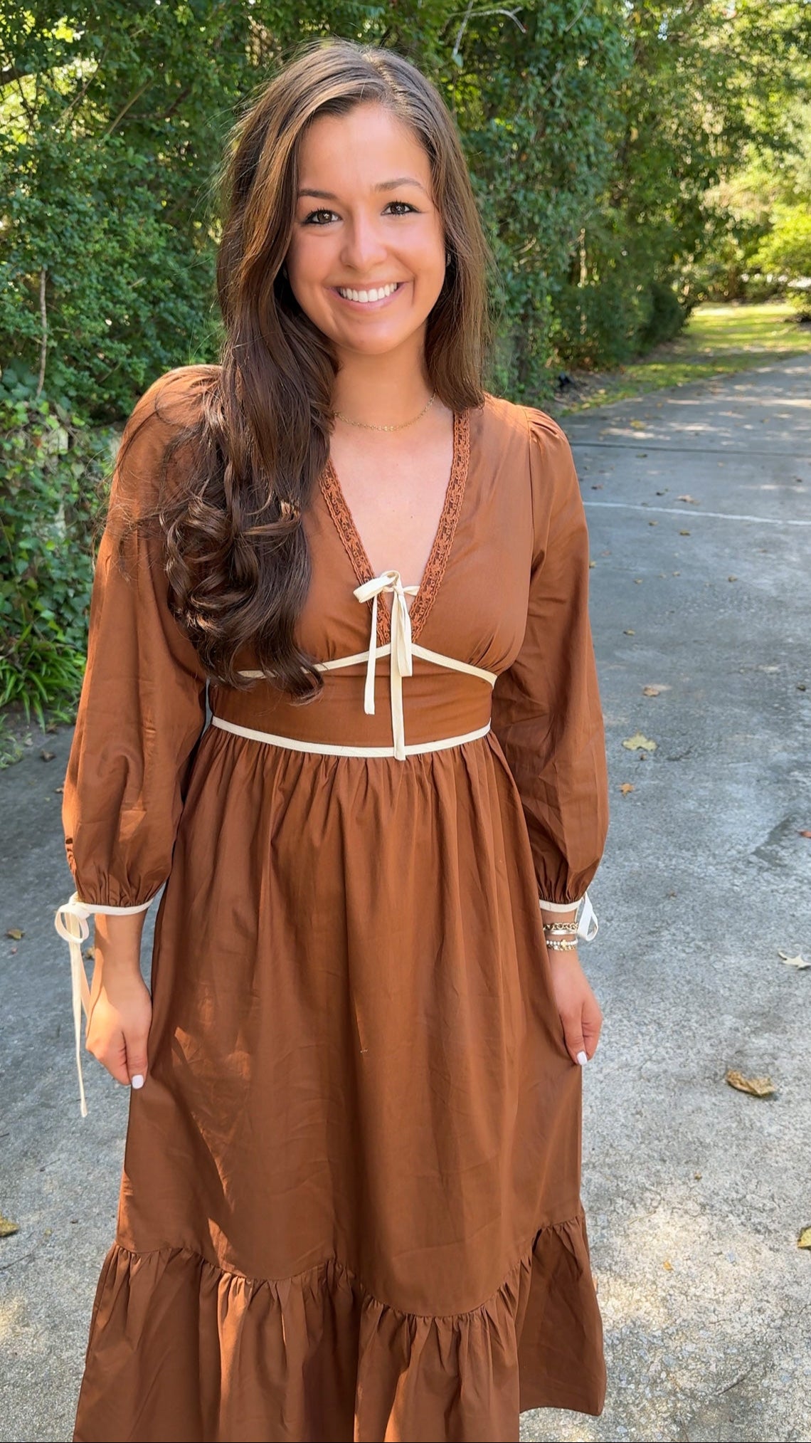 close up view orange brown rust midi dress with ivory cream details