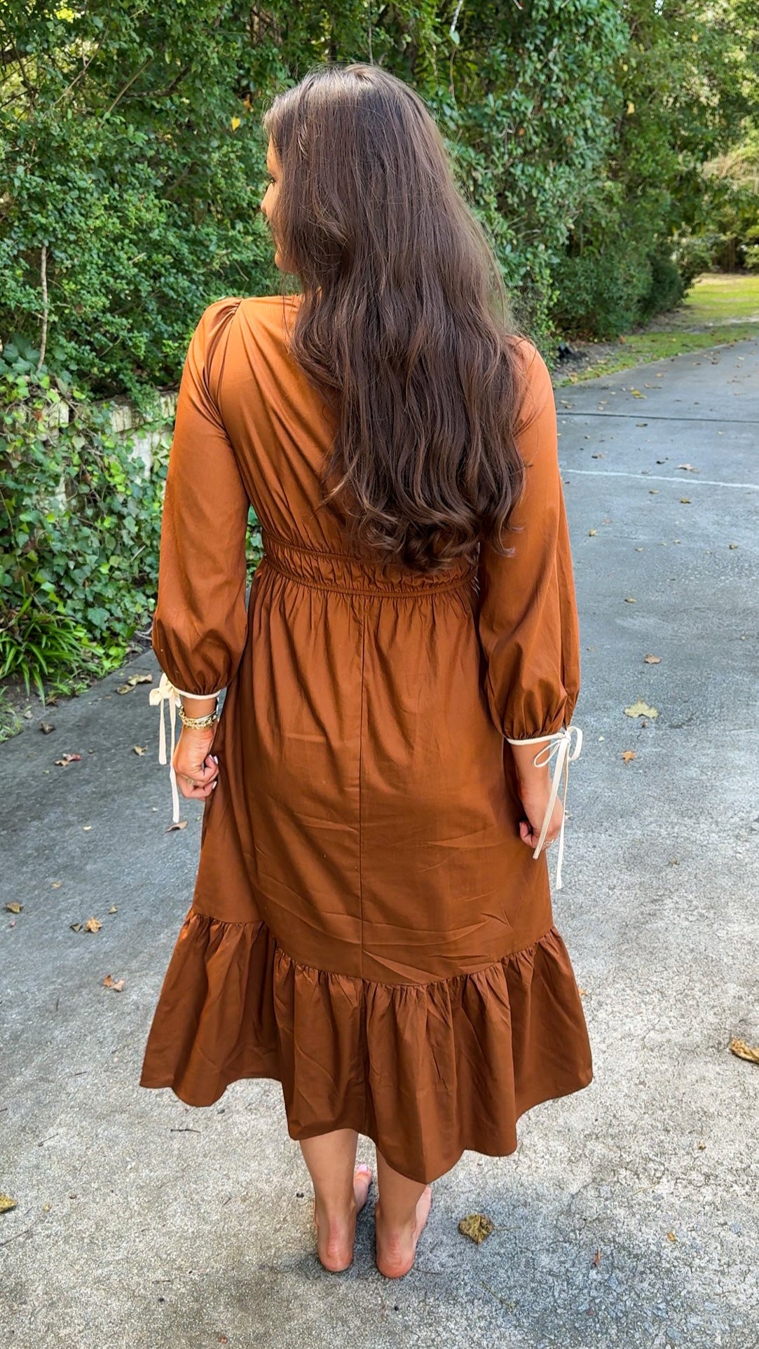 back view of orange brown rust midi dress with ivory cream details