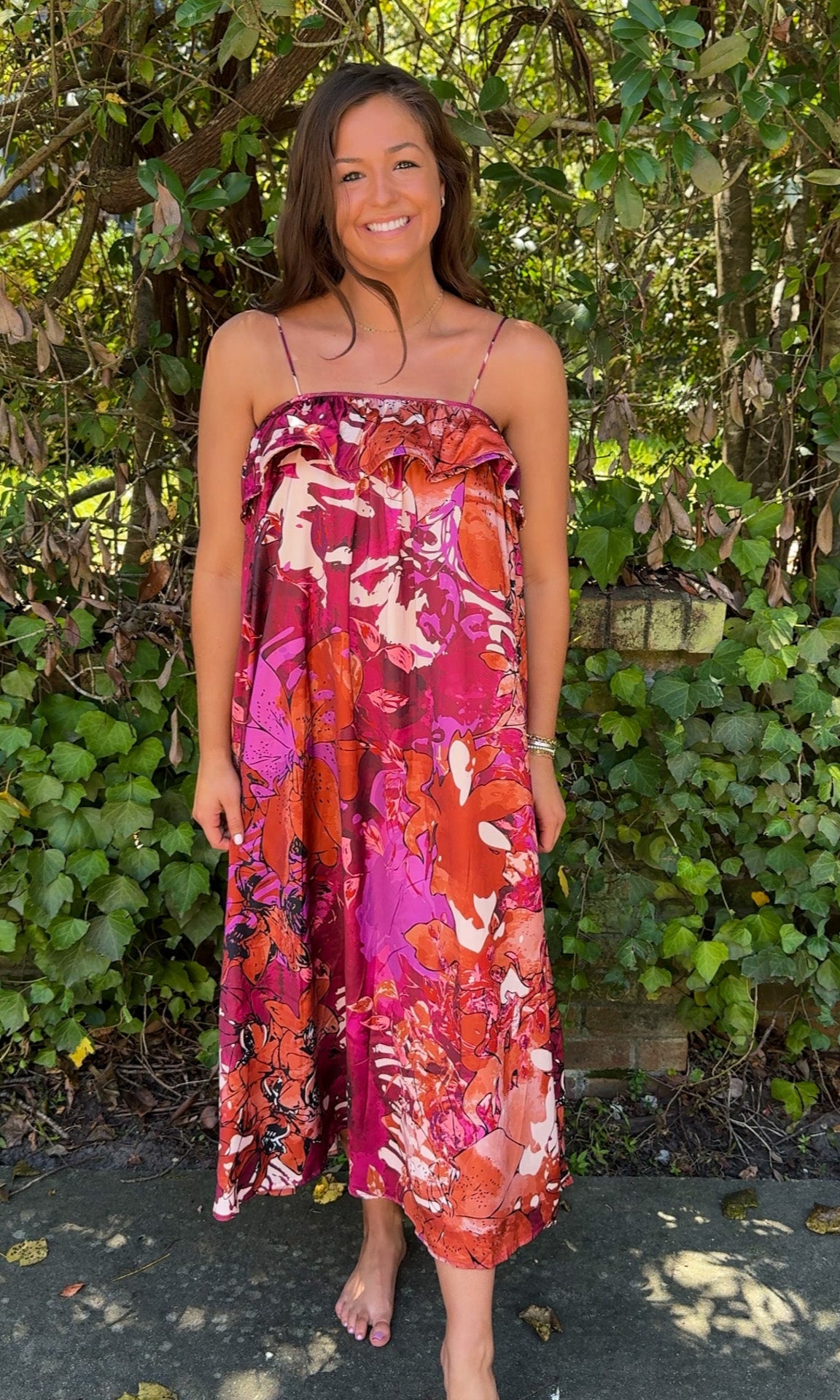 front far away view burgundy floral fall dress with spaghetti straps and ruffle top