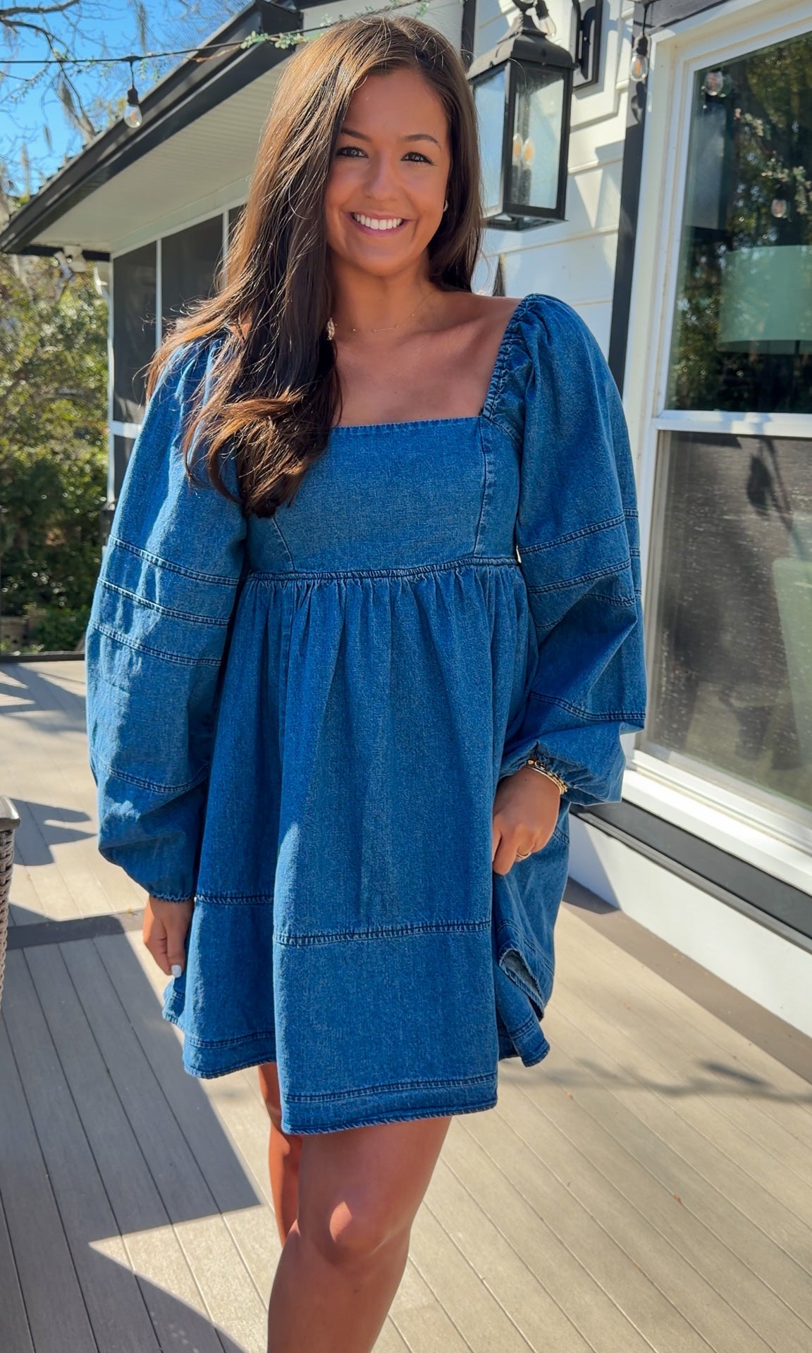 Women’s blue denim babydoll dress featuring a square neckline, long puff sleeves, and a loose, comfortable silhouette.