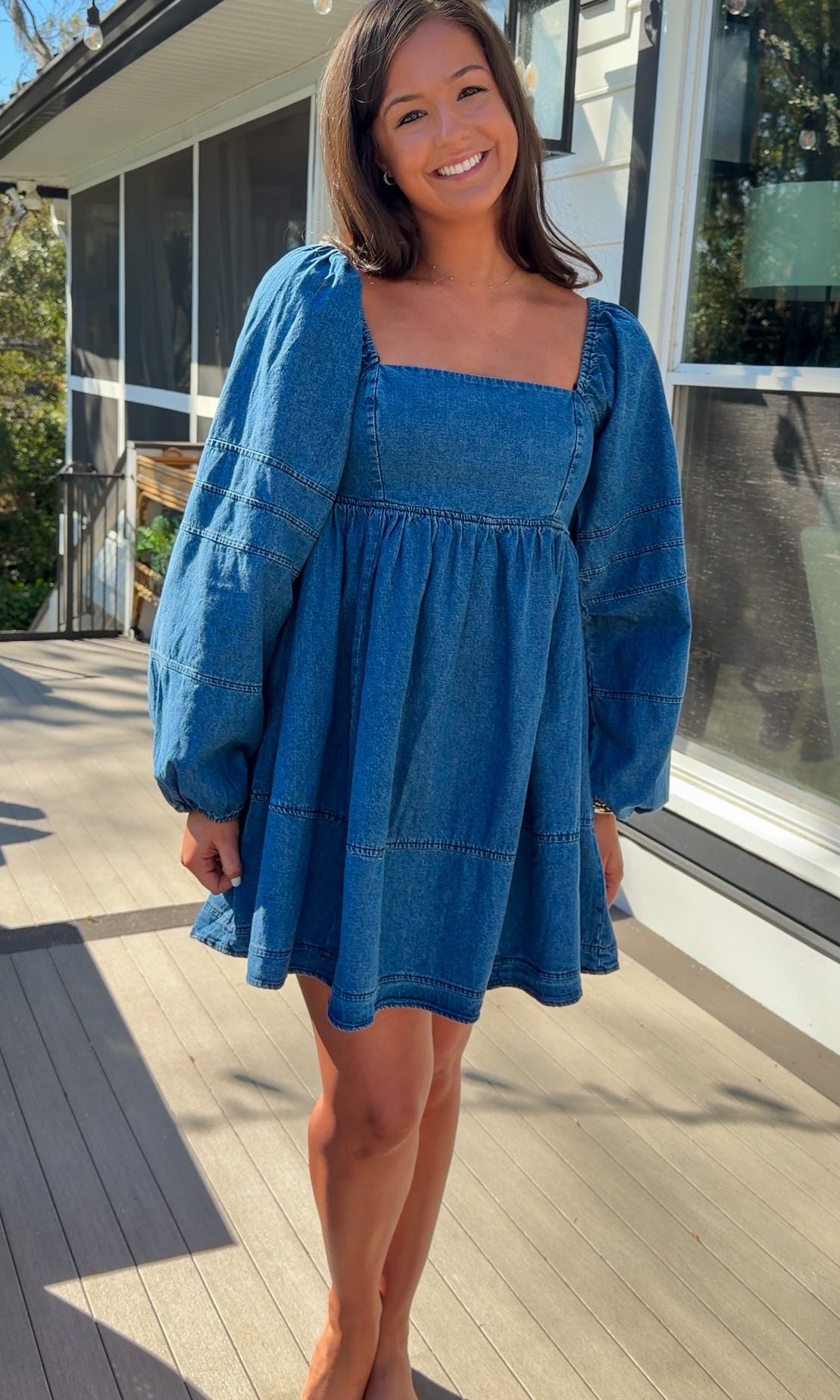 Women’s blue denim babydoll dress featuring a square neckline, long puff sleeves, and a loose, comfortable silhouette.