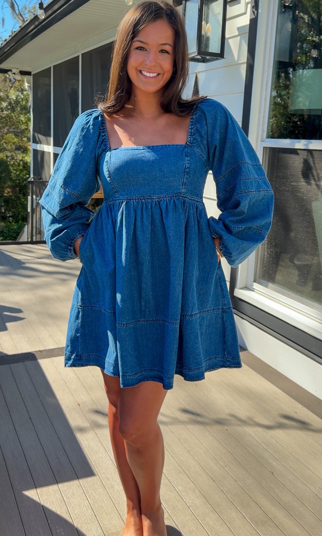 Women’s blue denim babydoll dress featuring a square neckline, long puff sleeves, and a loose, comfortable silhouette.