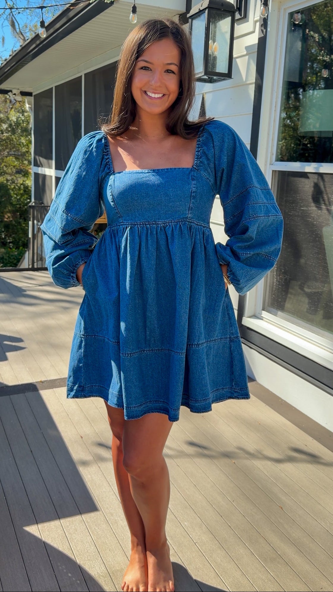 Women’s blue denim babydoll dress featuring a square neckline, long puff sleeves, and a loose, comfortable silhouette.