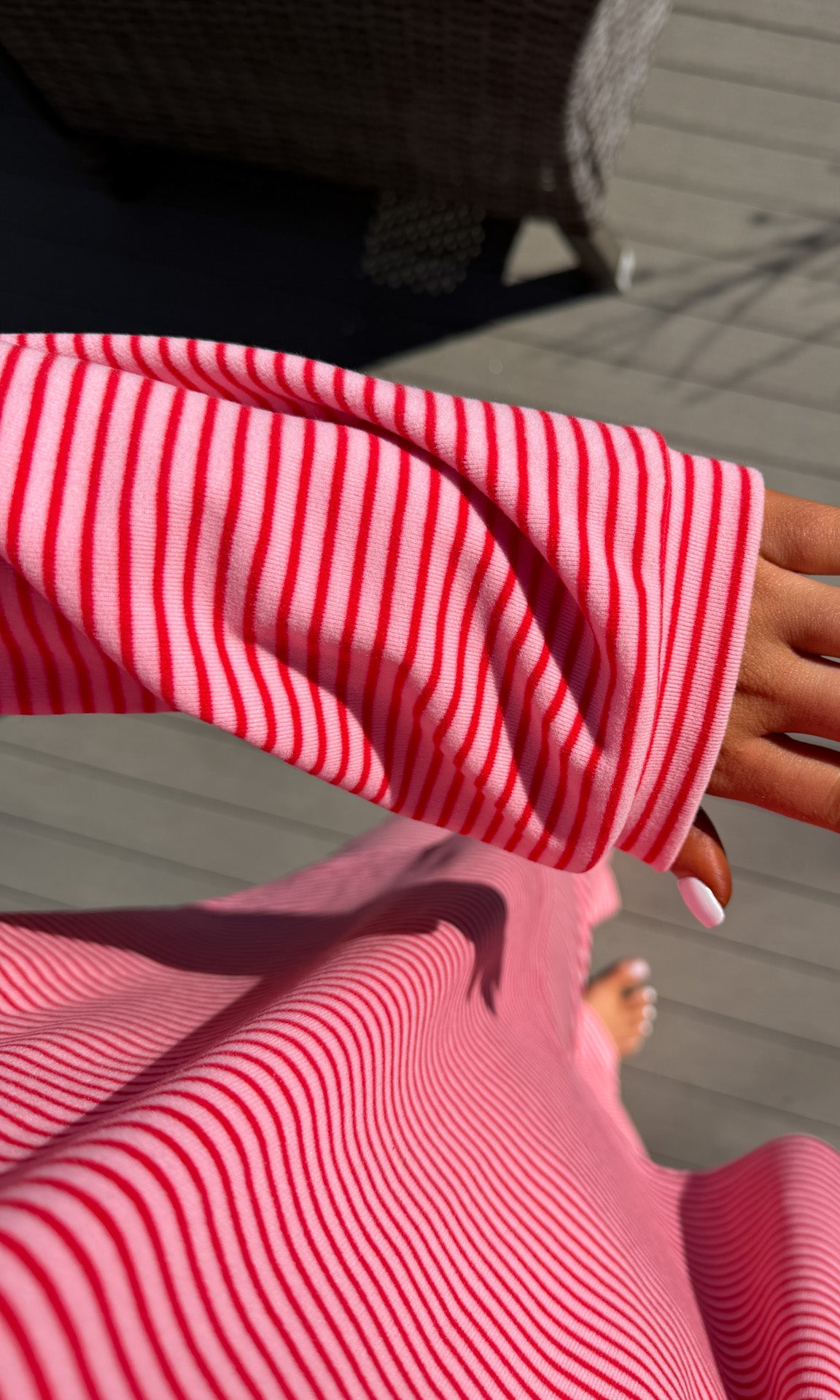 Close-up of a person wearing a red and white striped shirt with a blurred background