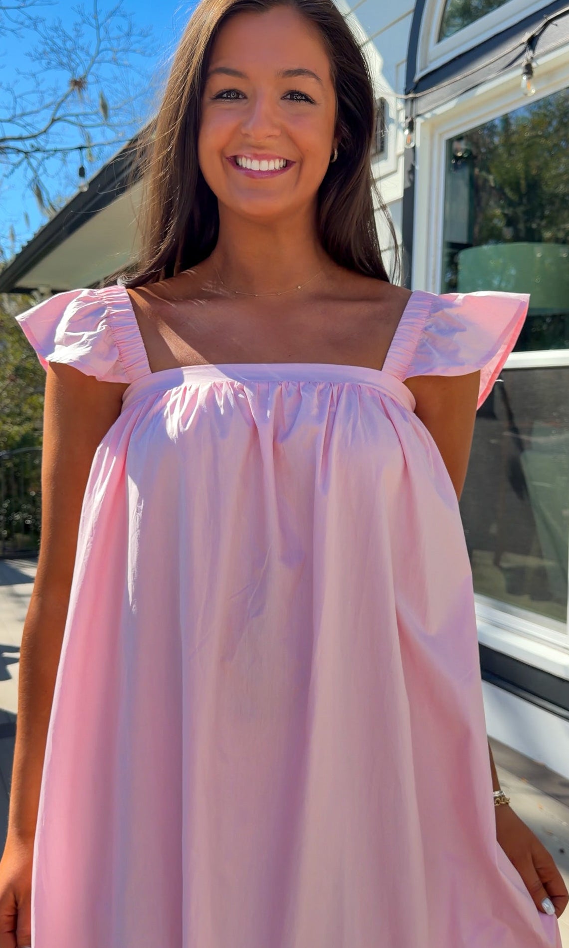 baby pink midi dress with flutter sleeves and tiered ruffle hem