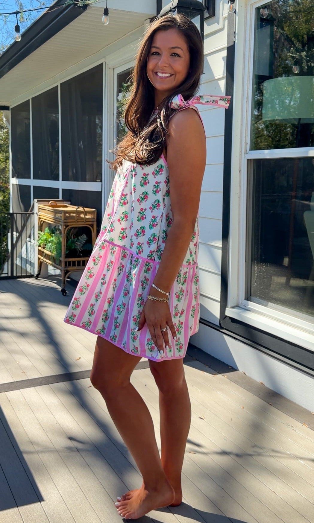 pink floral mini dress with ruffle hem and decorative shoulder bows