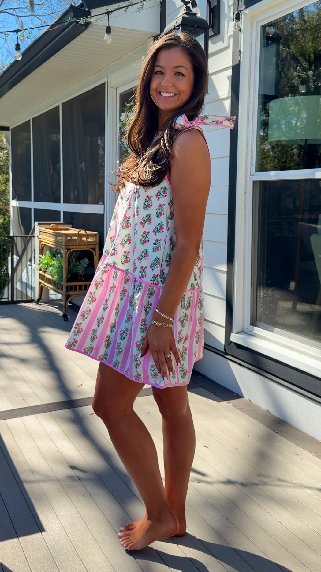 pink floral mini dress with ruffle hem and decorative shoulder bows