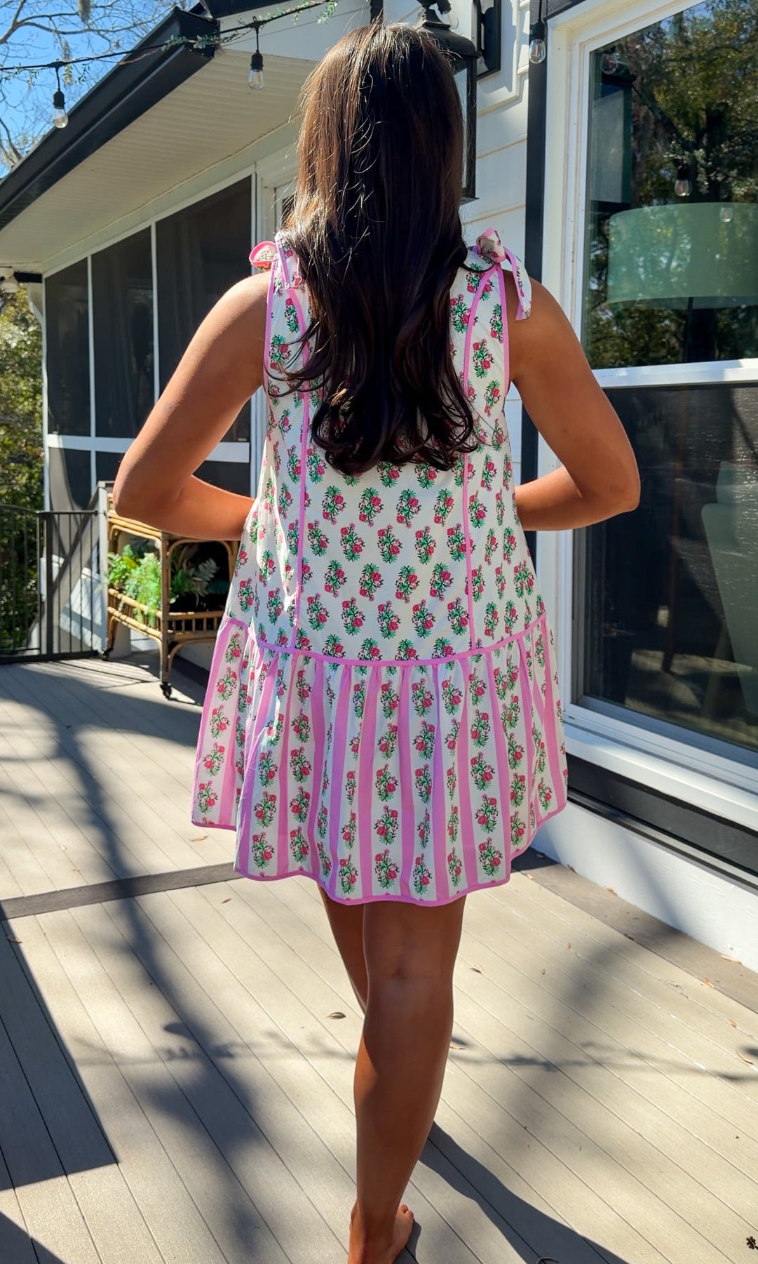 pink floral mini dress with ruffle hem and decorative shoulder bows