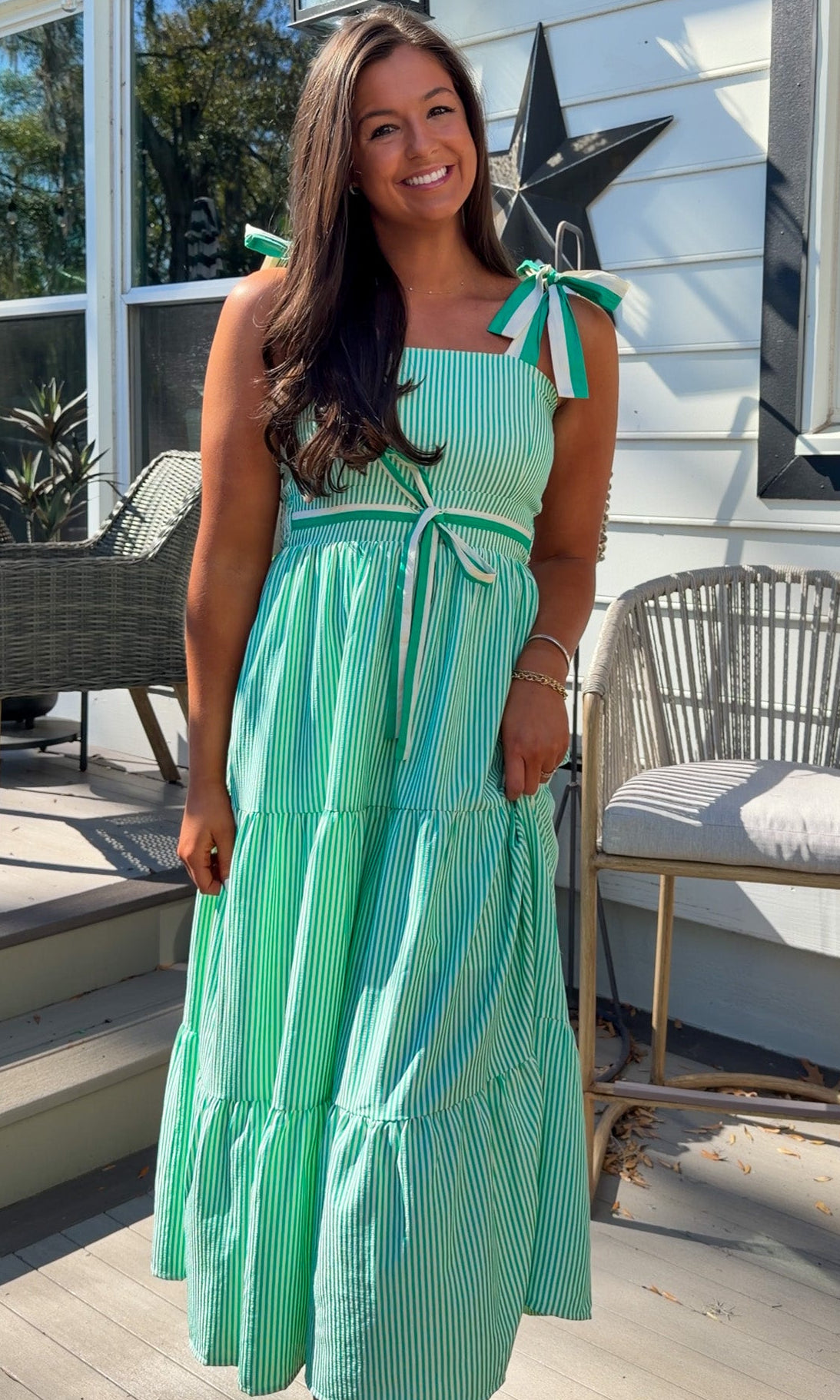 green striped tiered midi dress with bow tie straps and smocked back
