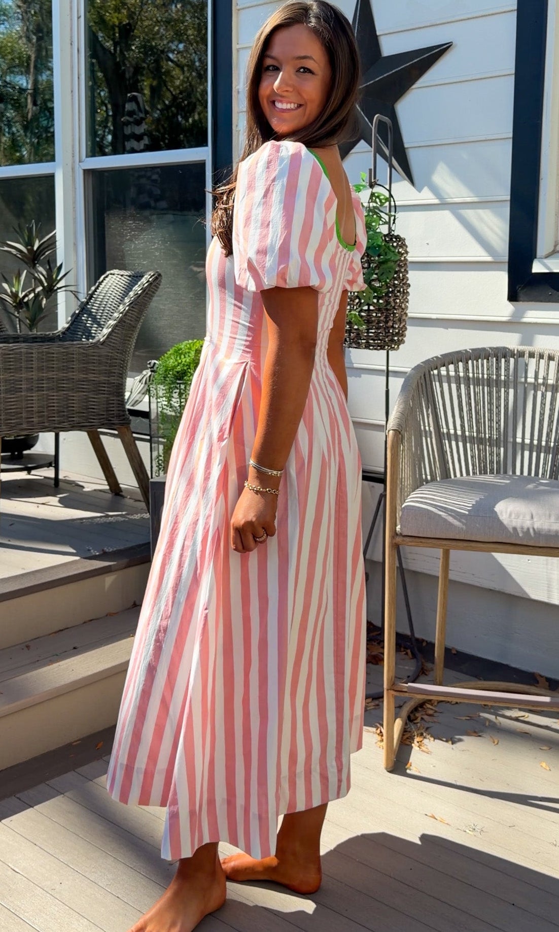pink striped midi dress with green contrast trim and puff sleeves