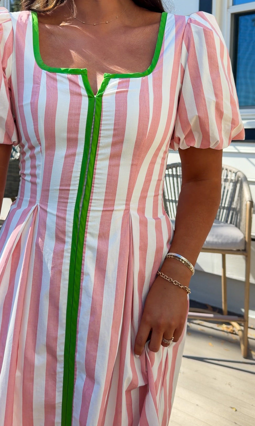 pink striped midi dress with green contrast trim and puff sleeves