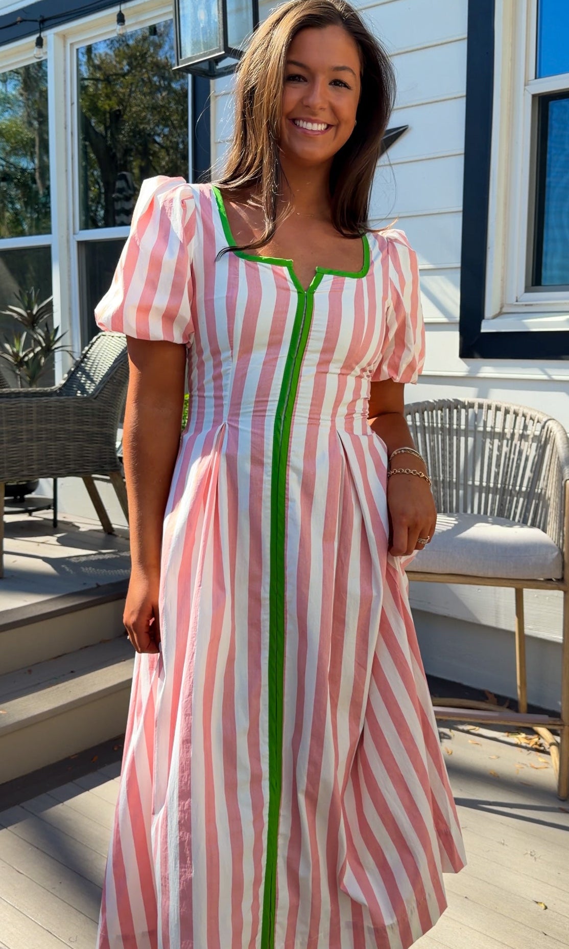 pink striped midi dress with green contrast trim and puff sleeves