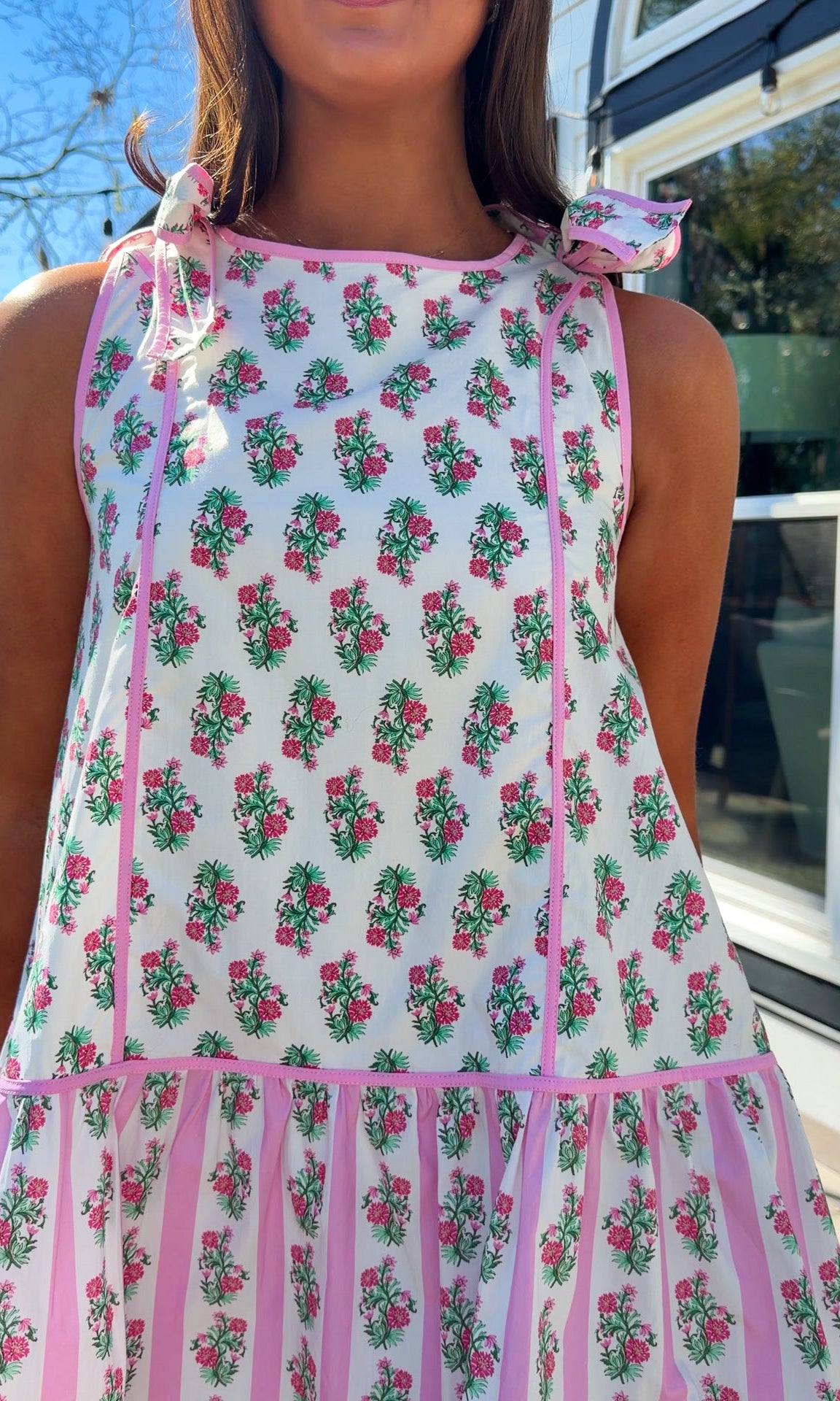 pink floral mini dress with ruffle hem and decorative shoulder bows