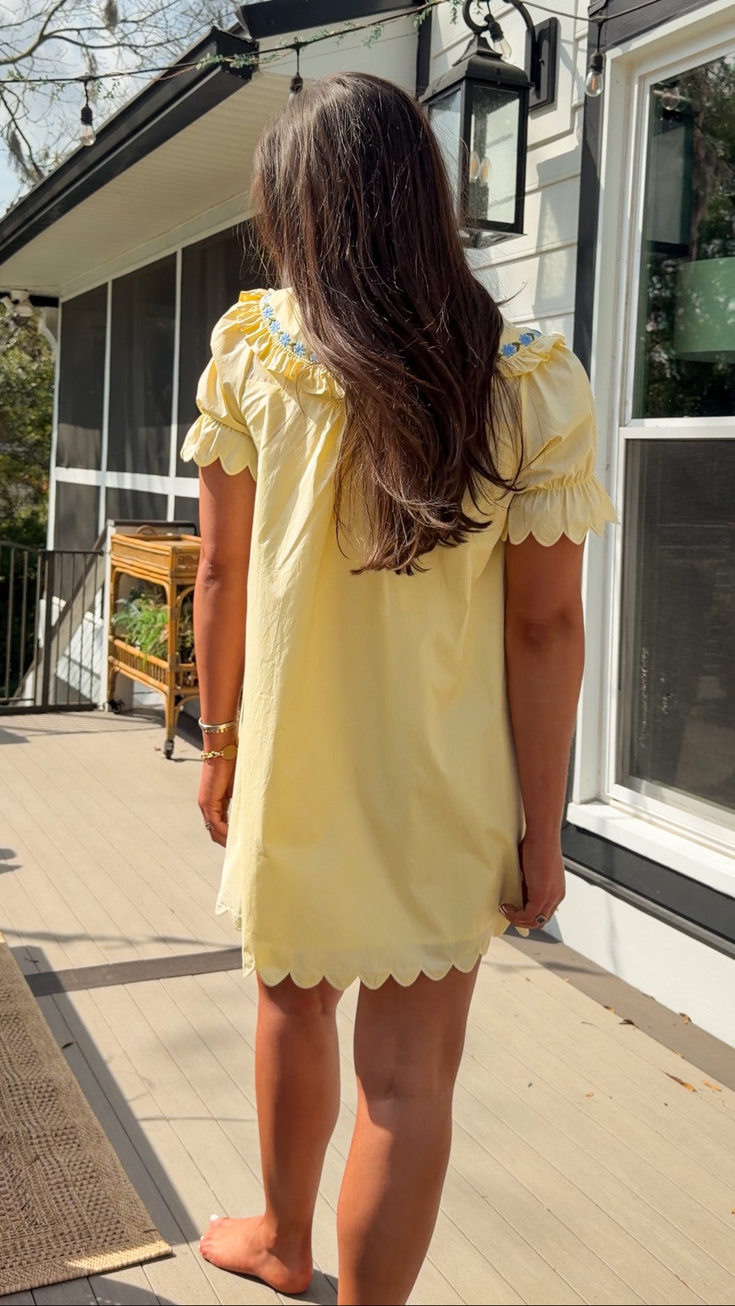 yellow mini dress with multicolor floral embroidery, ruffle collar, puff sleeves, and scalloped hem