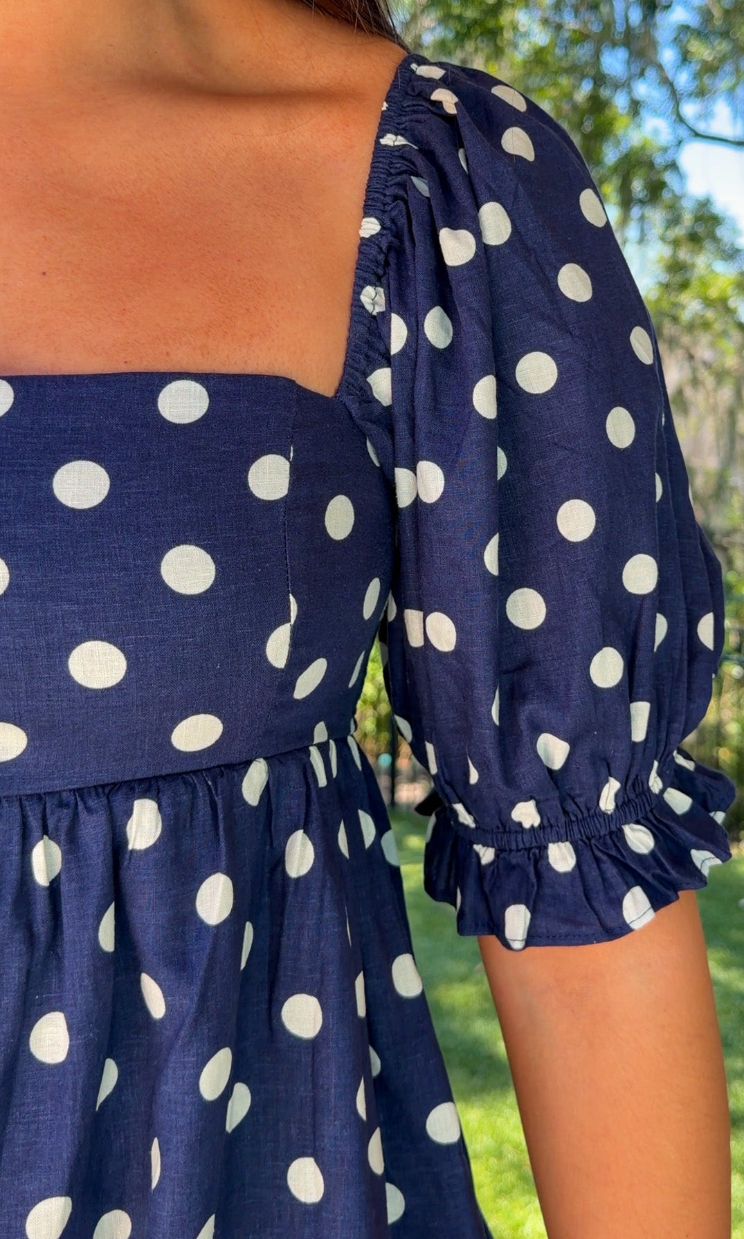 navy blue romper with white polka dots