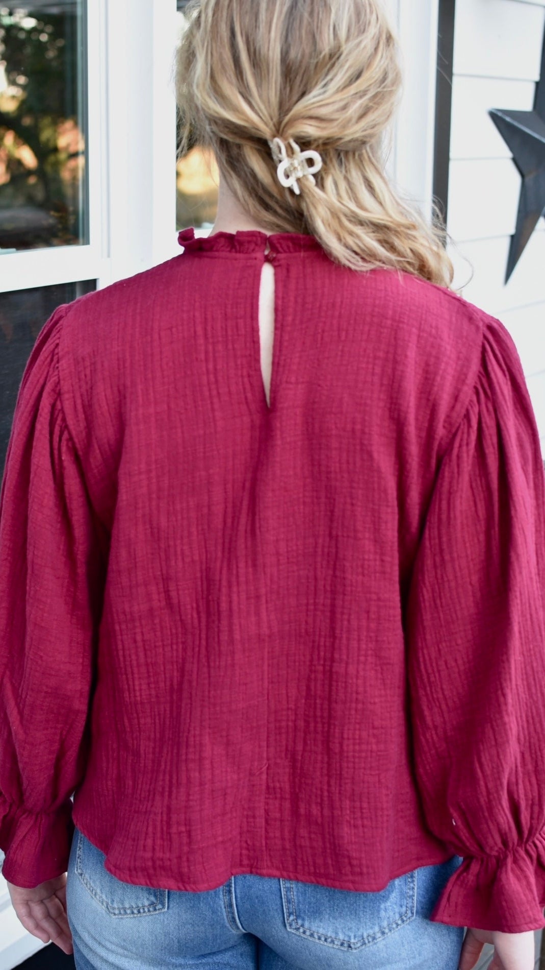 burgundy top with long sleeves, back view
