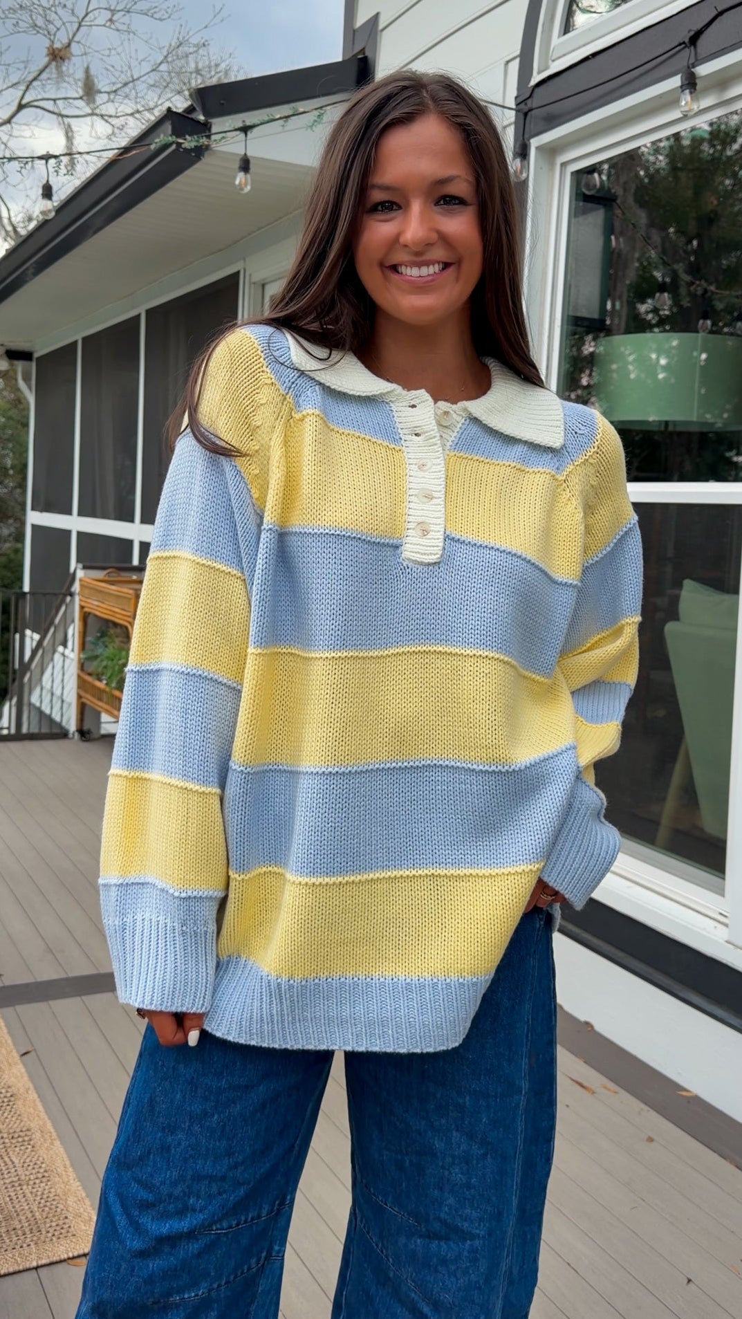 Oversized blue and yellow striped collared knit sweater with button placket