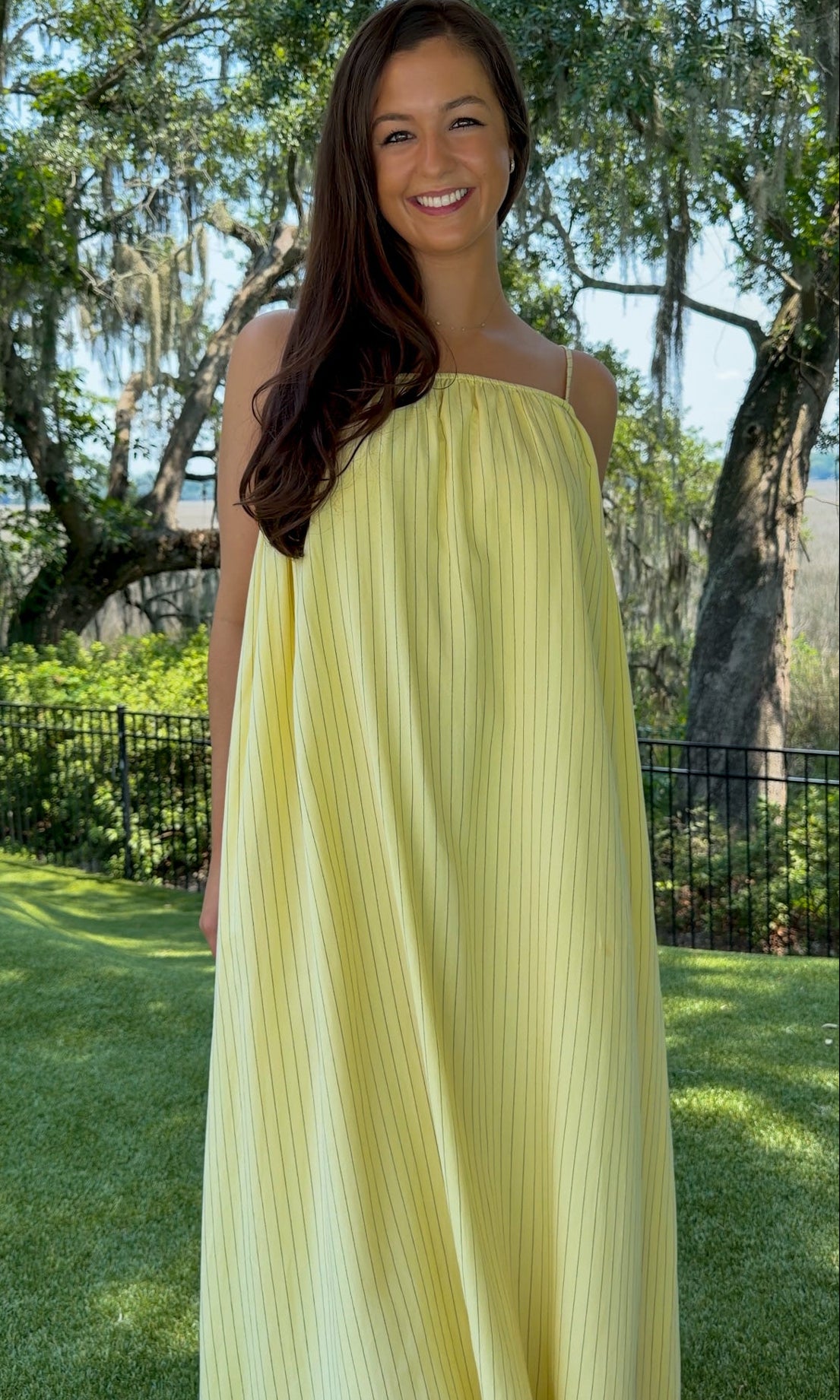 Butter yellow pinstripe maxi dress featuring adjustable spaghetti straps, a gathered square neckline, and a relaxed flowy silhouette in a lightweight woven fabric.