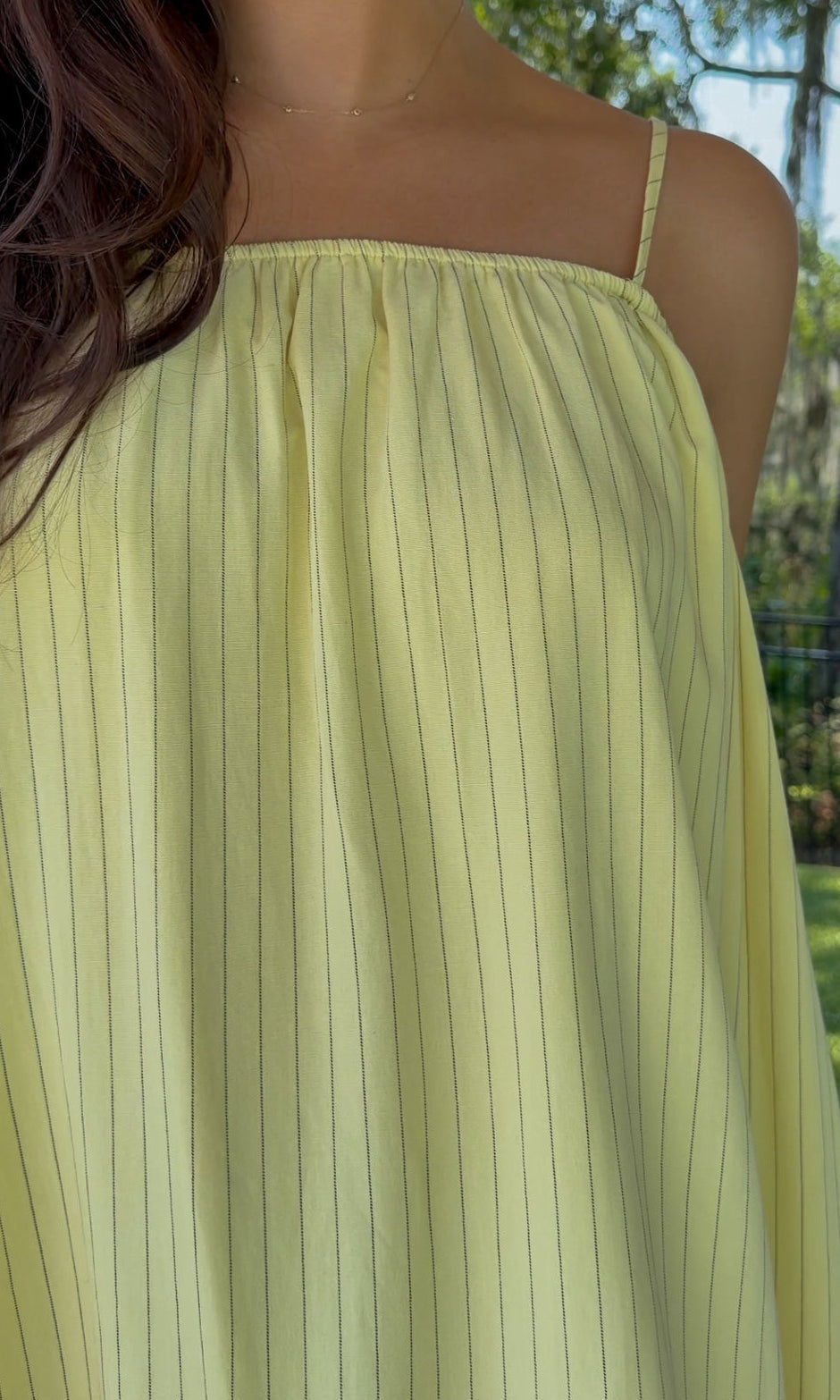 Butter yellow pinstripe maxi dress featuring adjustable spaghetti straps, a gathered square neckline, and a relaxed flowy silhouette in a lightweight woven fabric.
